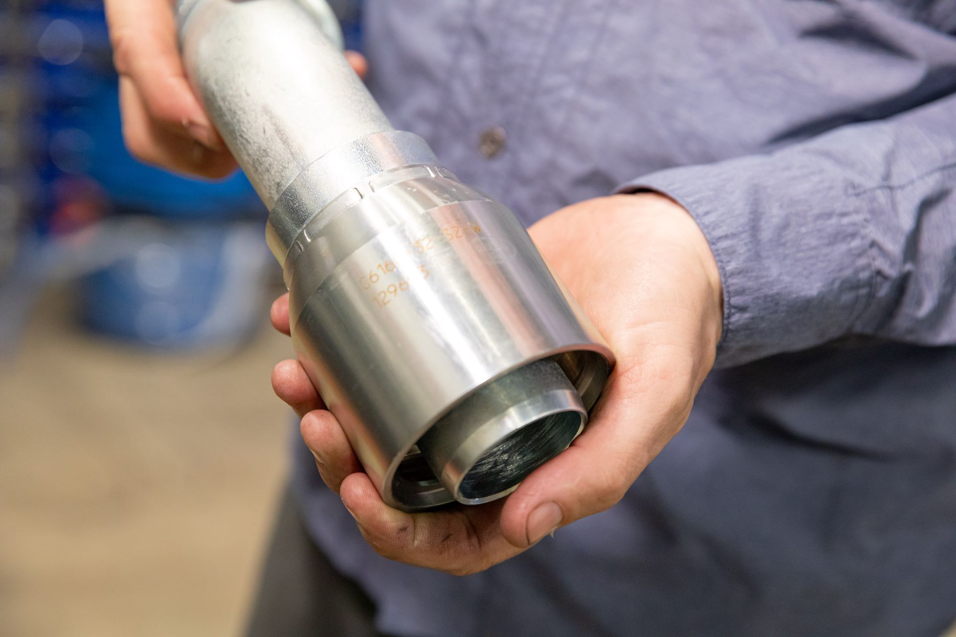 A person is holding a metal object in their hands.
