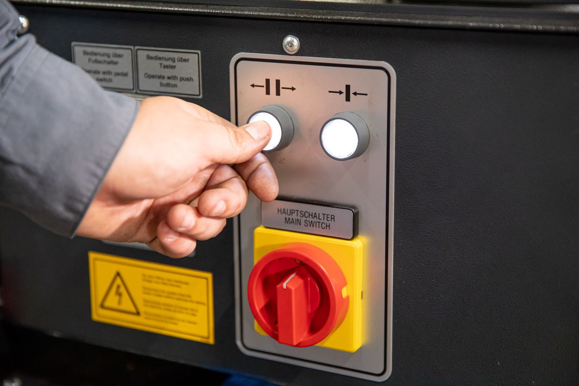 A person is pressing a button on a machine.