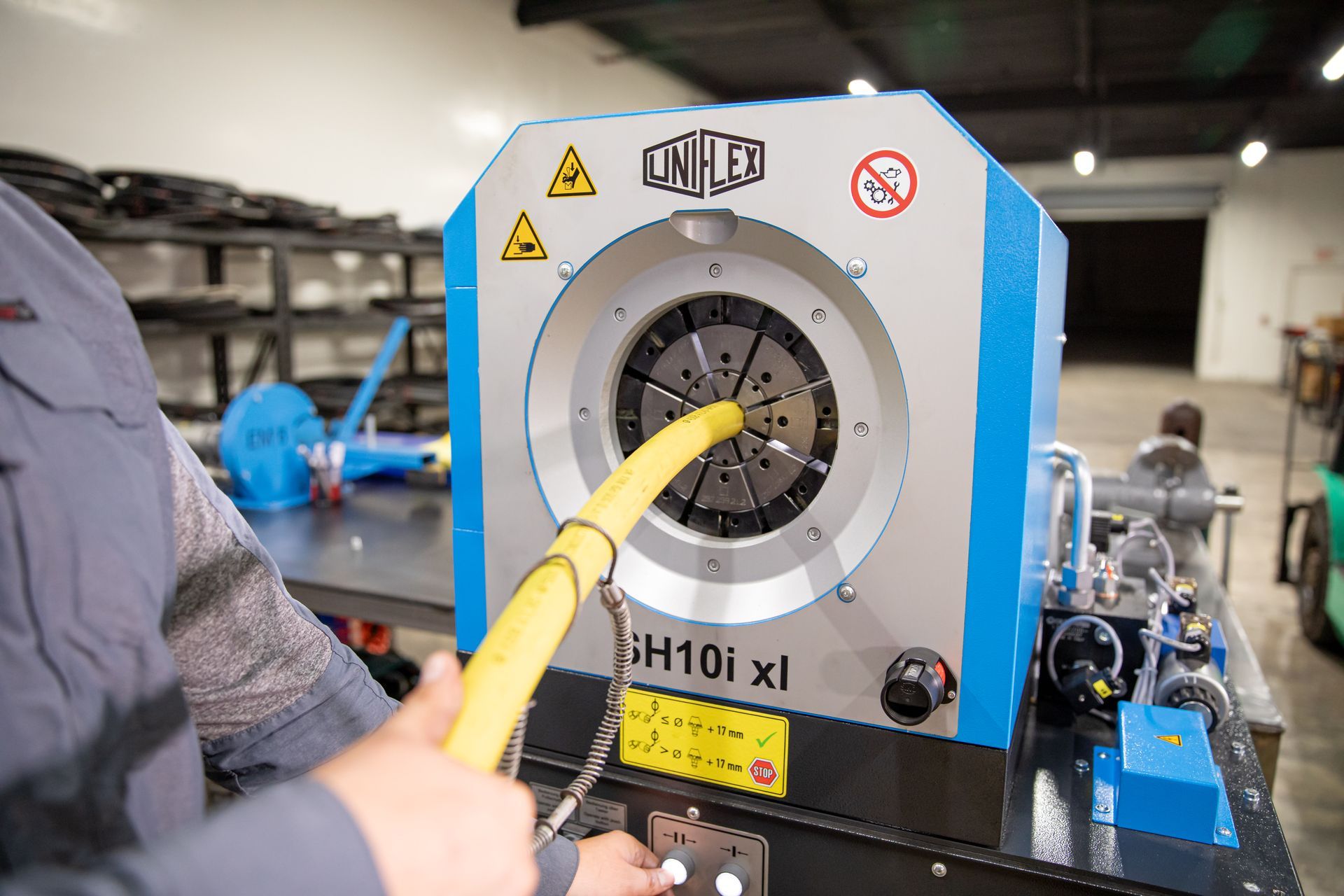 A man is working on a machine in a workshop.