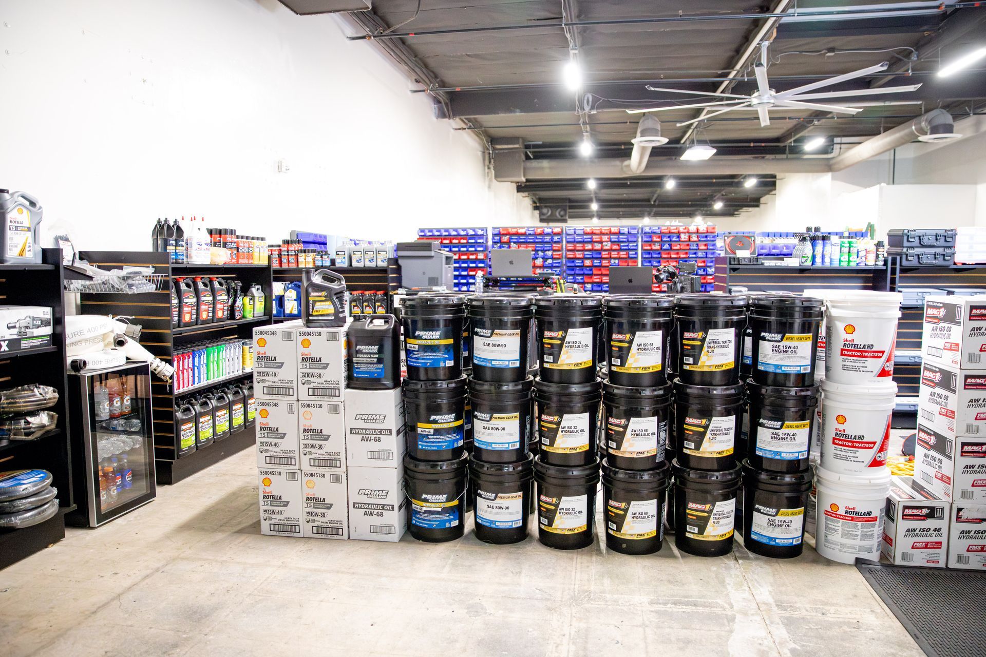A store filled with lots of buckets and boxes of oil.