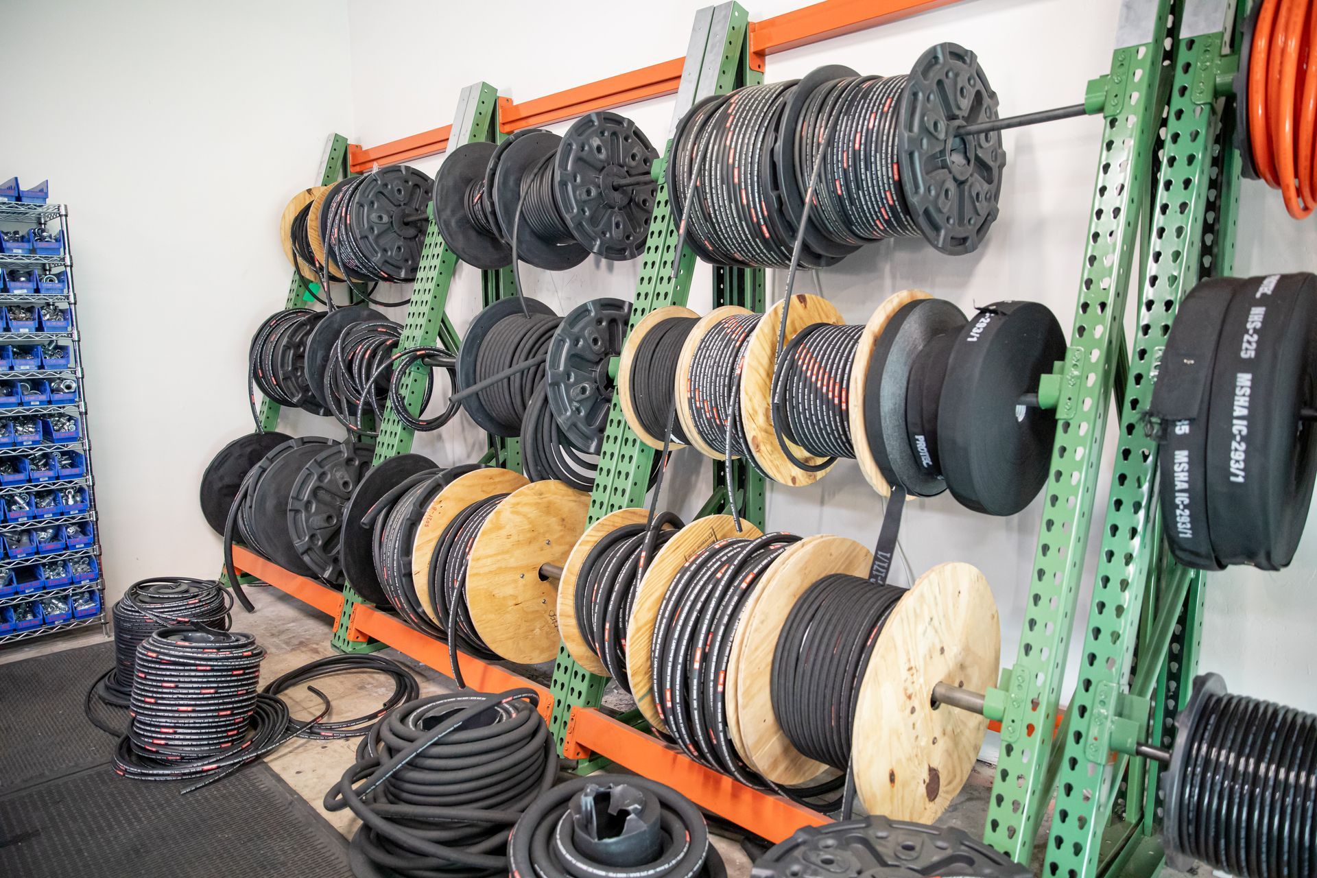 A warehouse filled with lots of spools of hydraulic and industrial hoses.