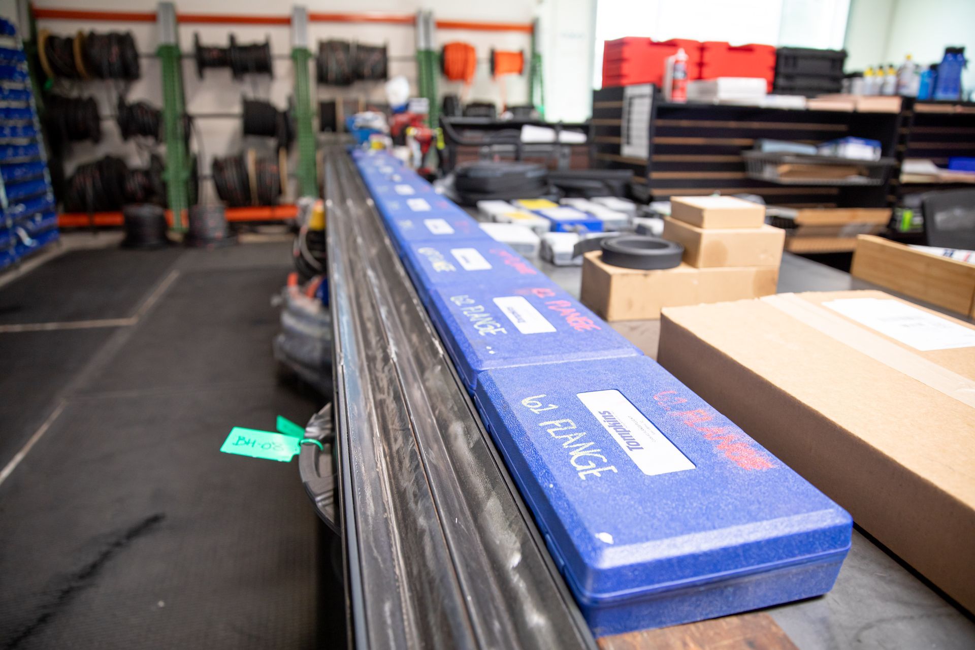 A row of blue boxes on a table in a warehouse