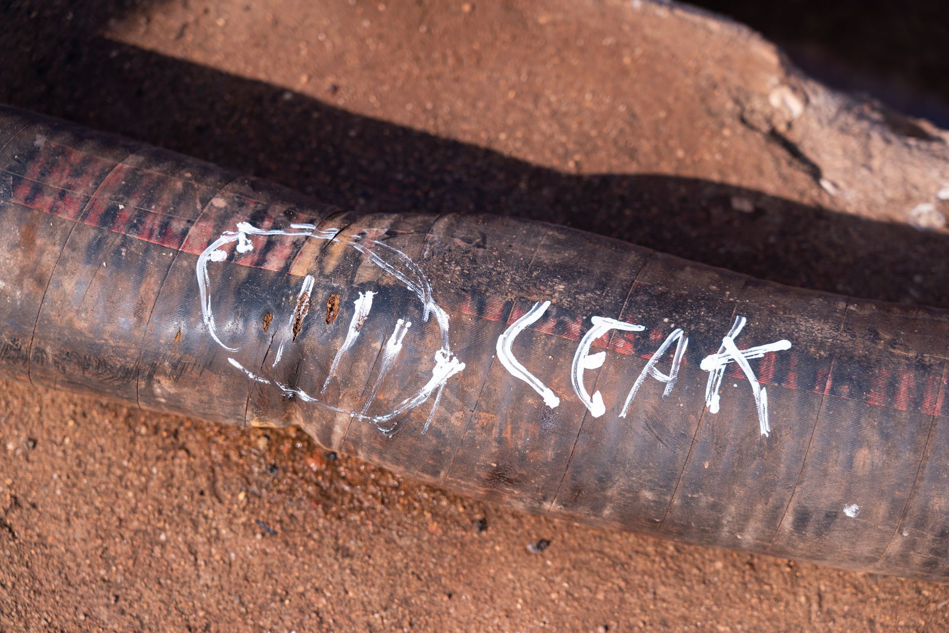 A close up of a hydraulic pipe with holes in it and the word 