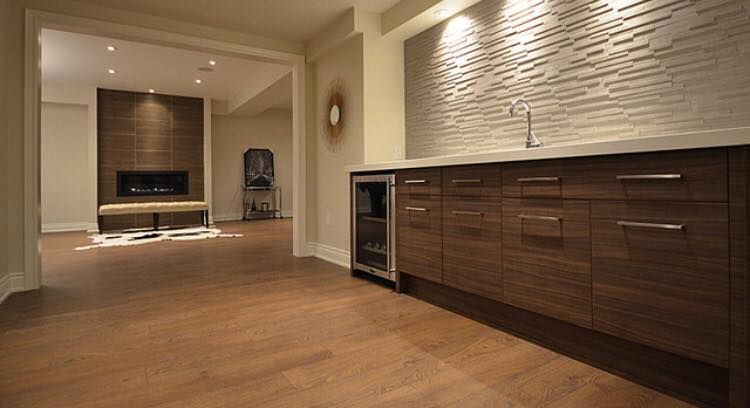 A kitchen with wooden cabinets and a refrigerator.