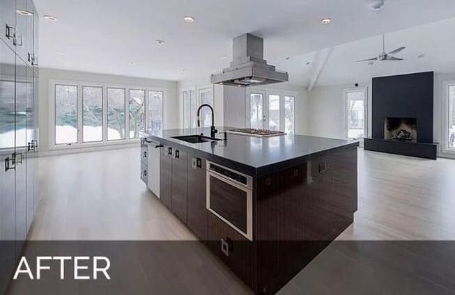 A kitchen with a large island and a stove top oven.