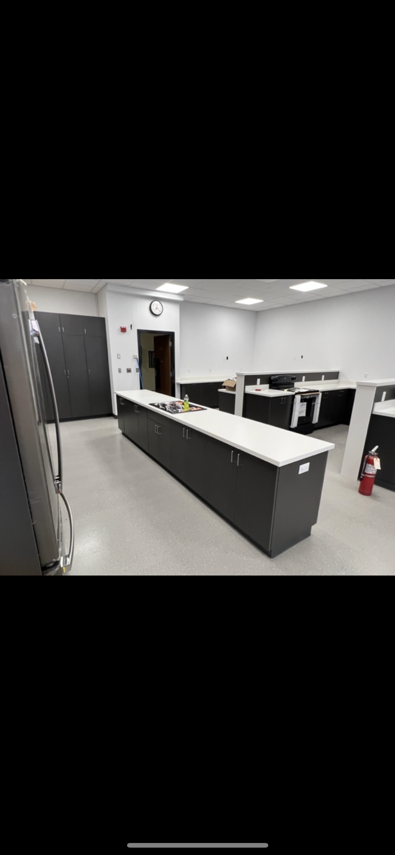 A large room with a long counter in the middle of it.