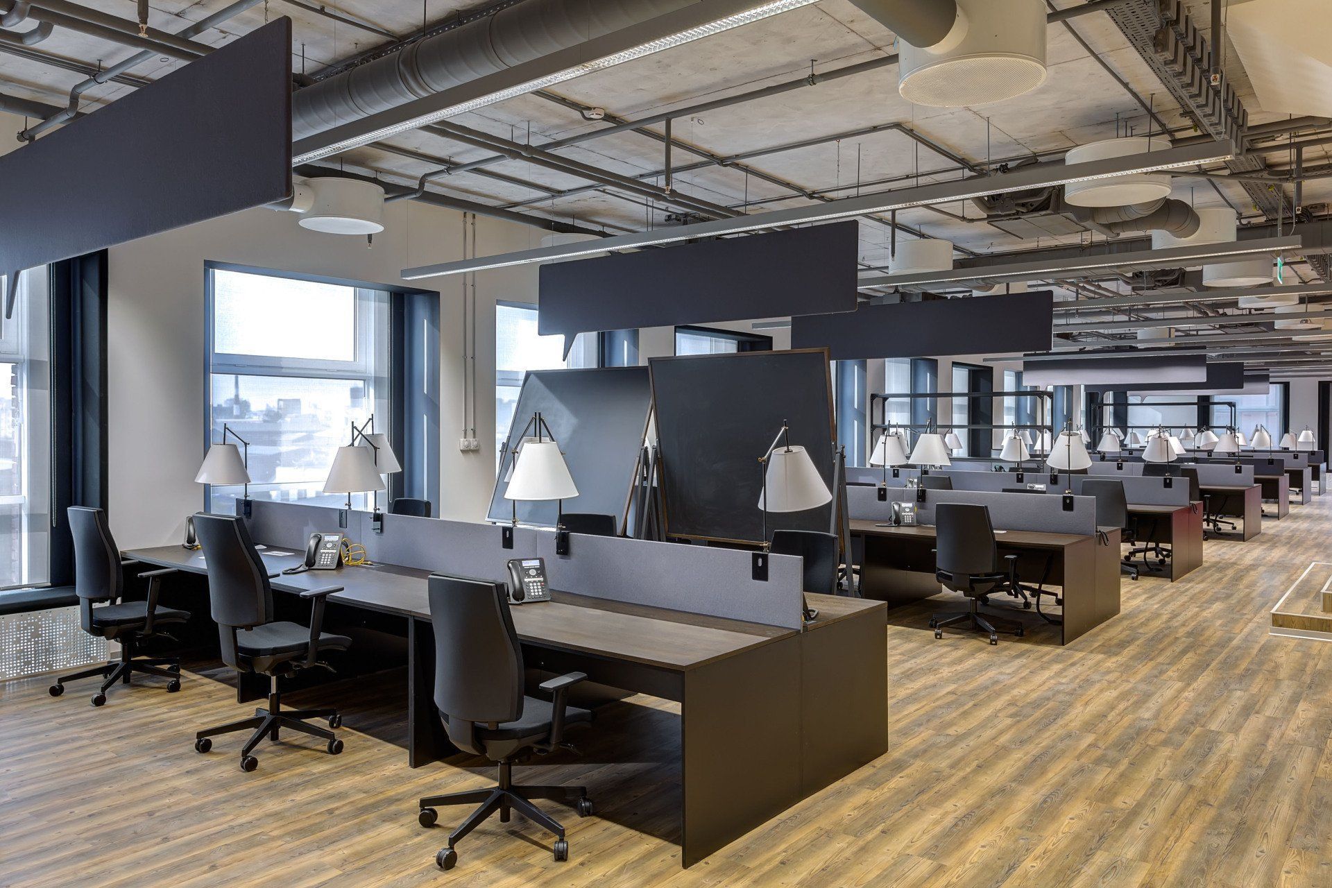 A large office with a lot of desks and chairs.