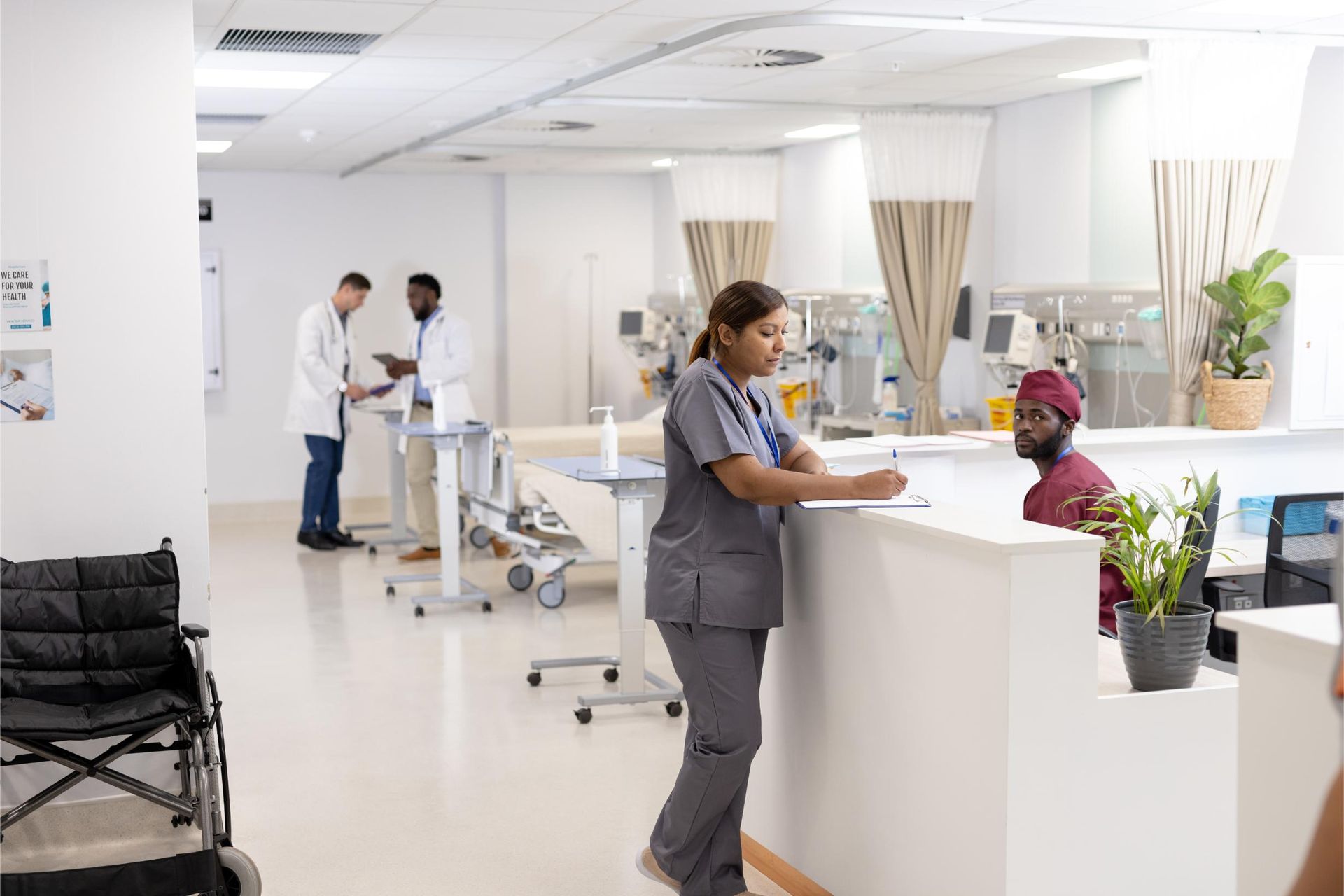 A nurse is standing at a counter in a hospital.