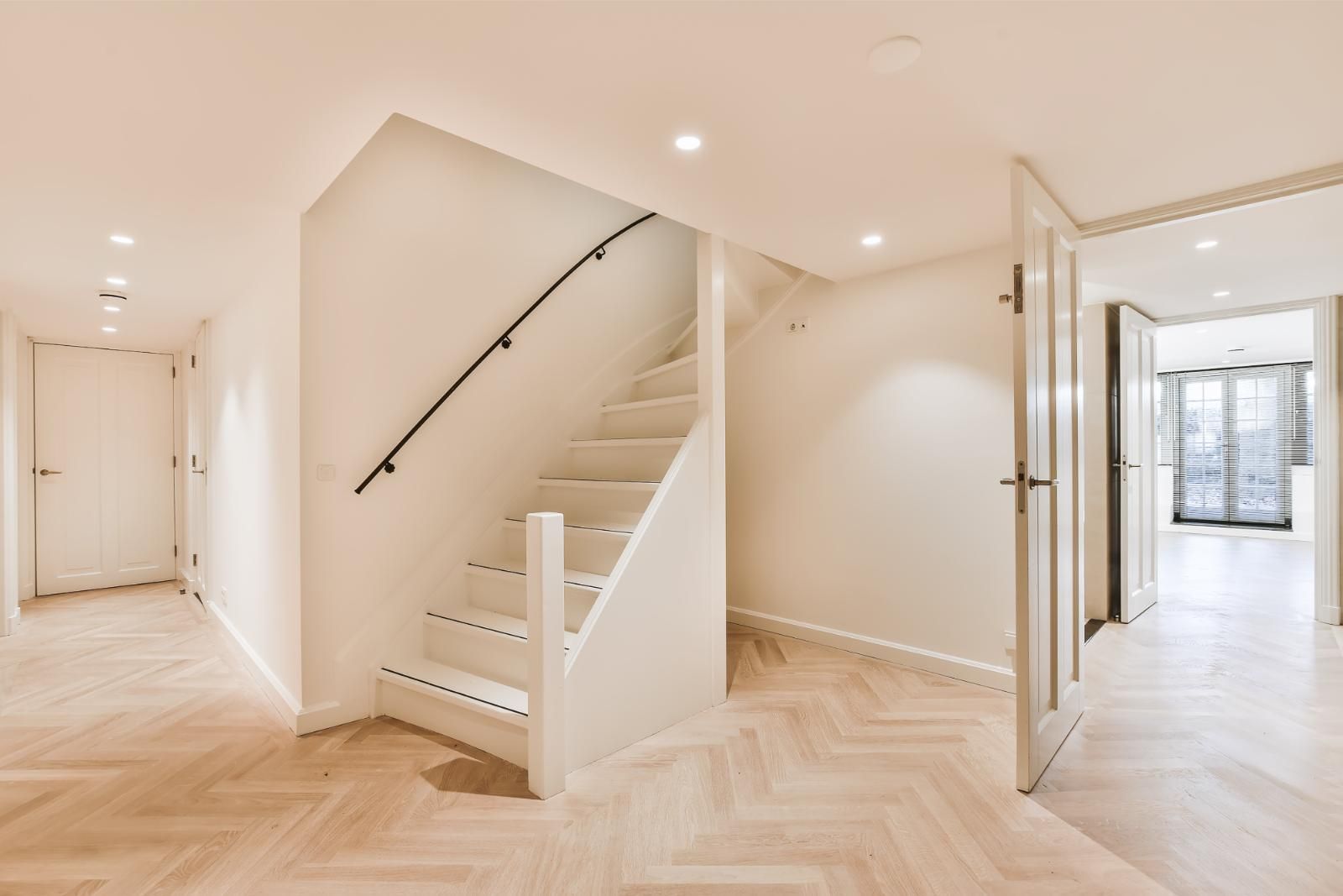 There is a staircase in the middle of the hallway.