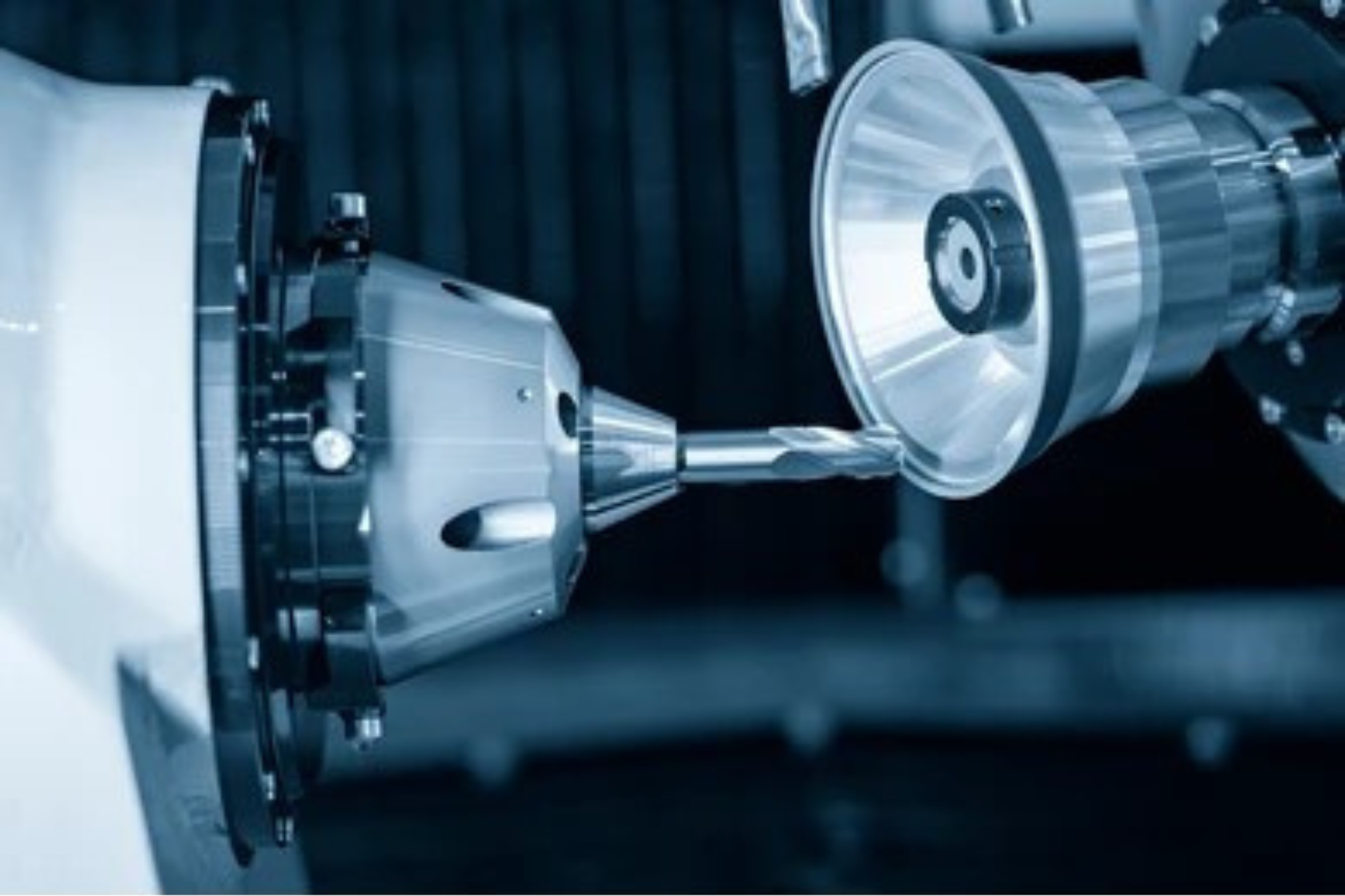 A person is using a machine to cut a piece of metal.