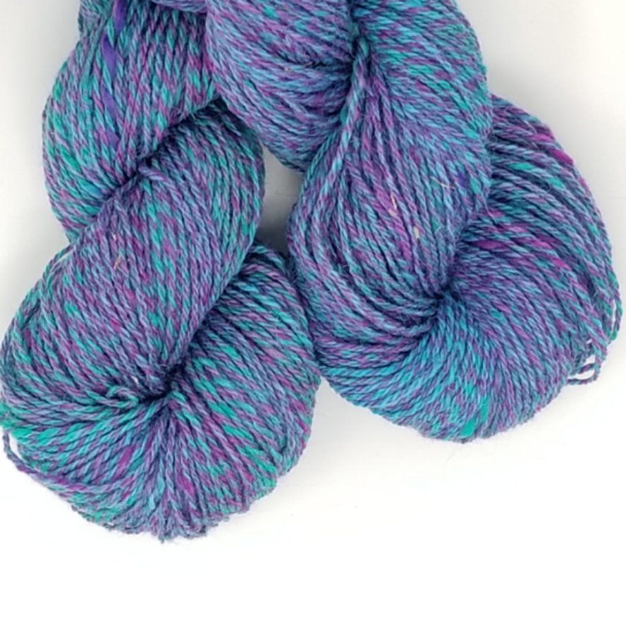 Skeins of colorful yarn: shades of blue, purple, and teal.