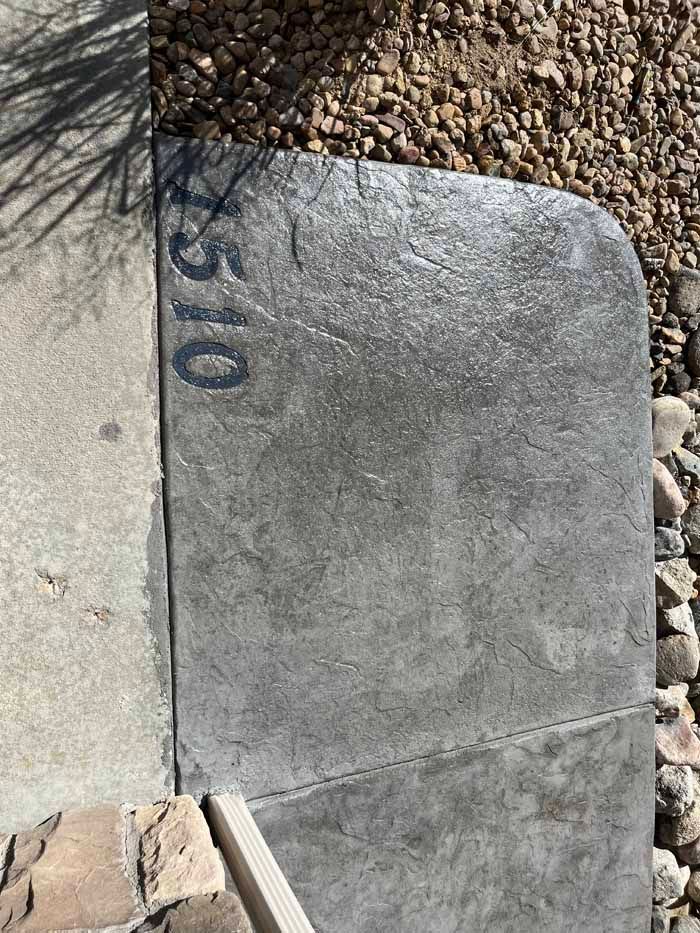 Concrete sidewalk with address 