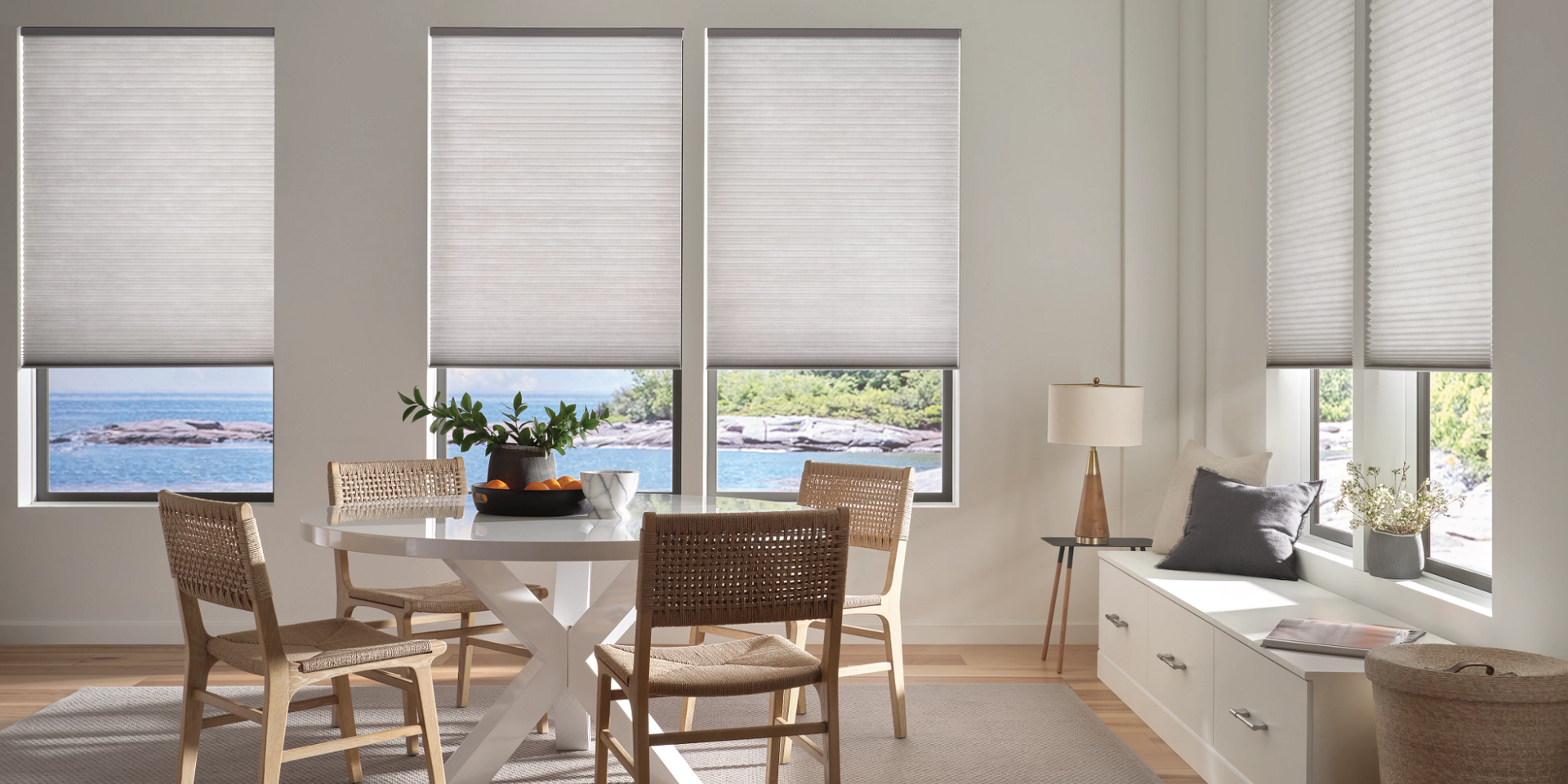 Hunter Douglas Duette® Cellular Shades on dining room windows, overlooking a body of water