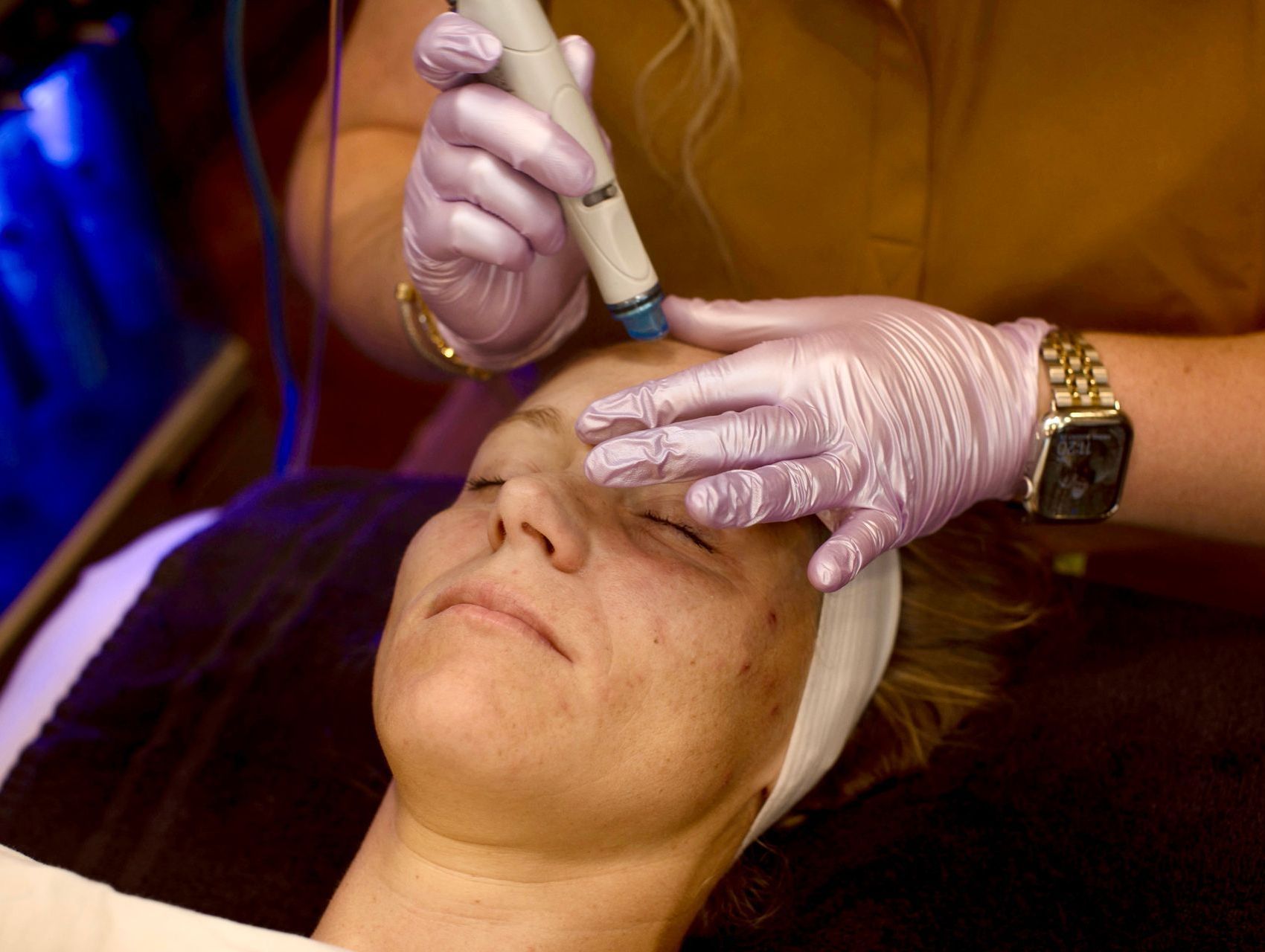 A woman is getting a facial treatment at a spa.