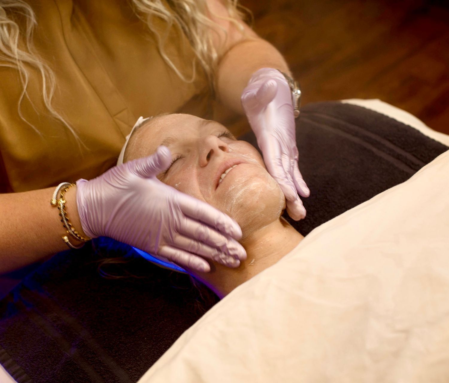 A woman is getting a facial treatment at a spa.