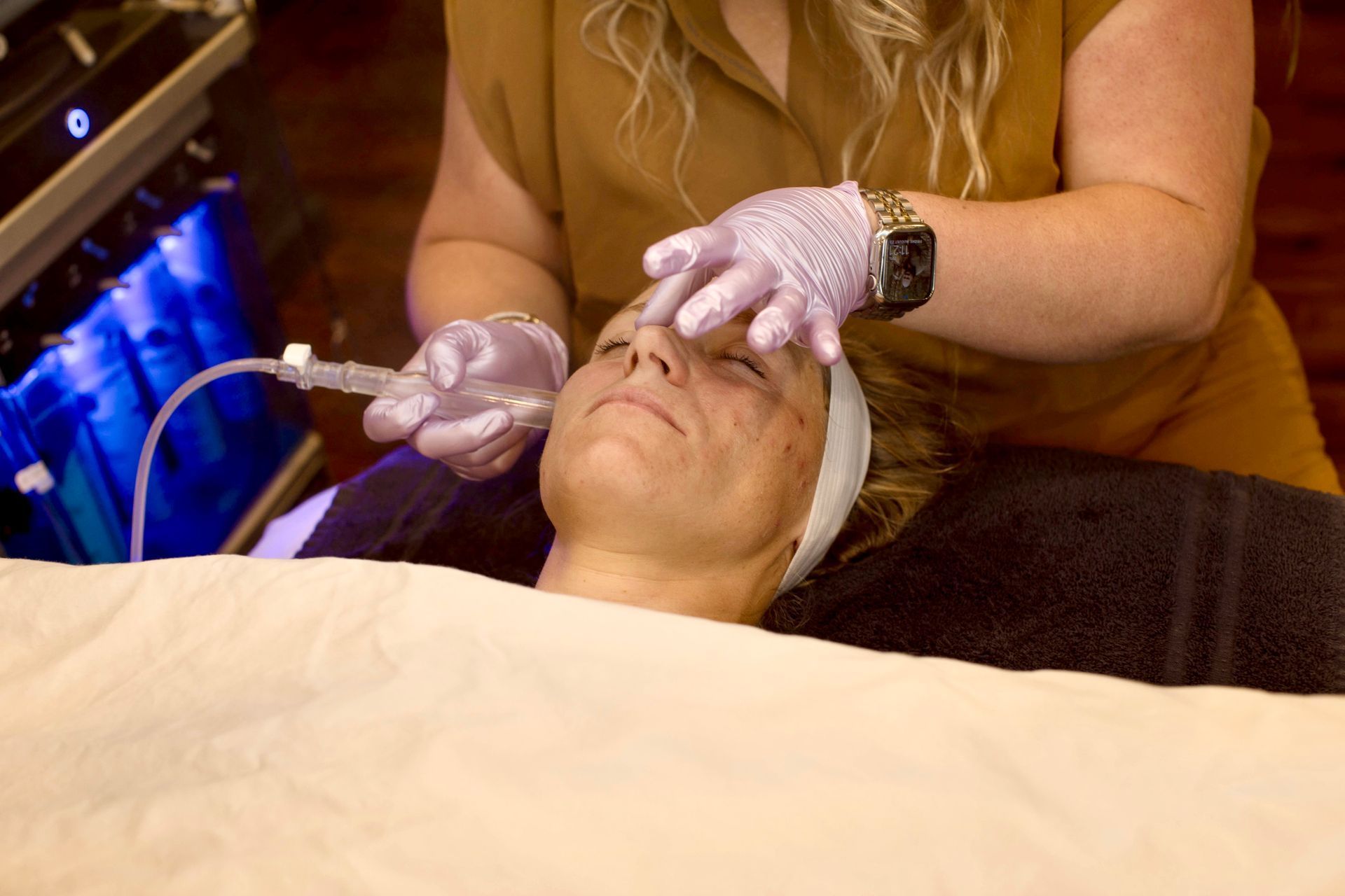 A woman is getting a facial treatment at a beauty salon.