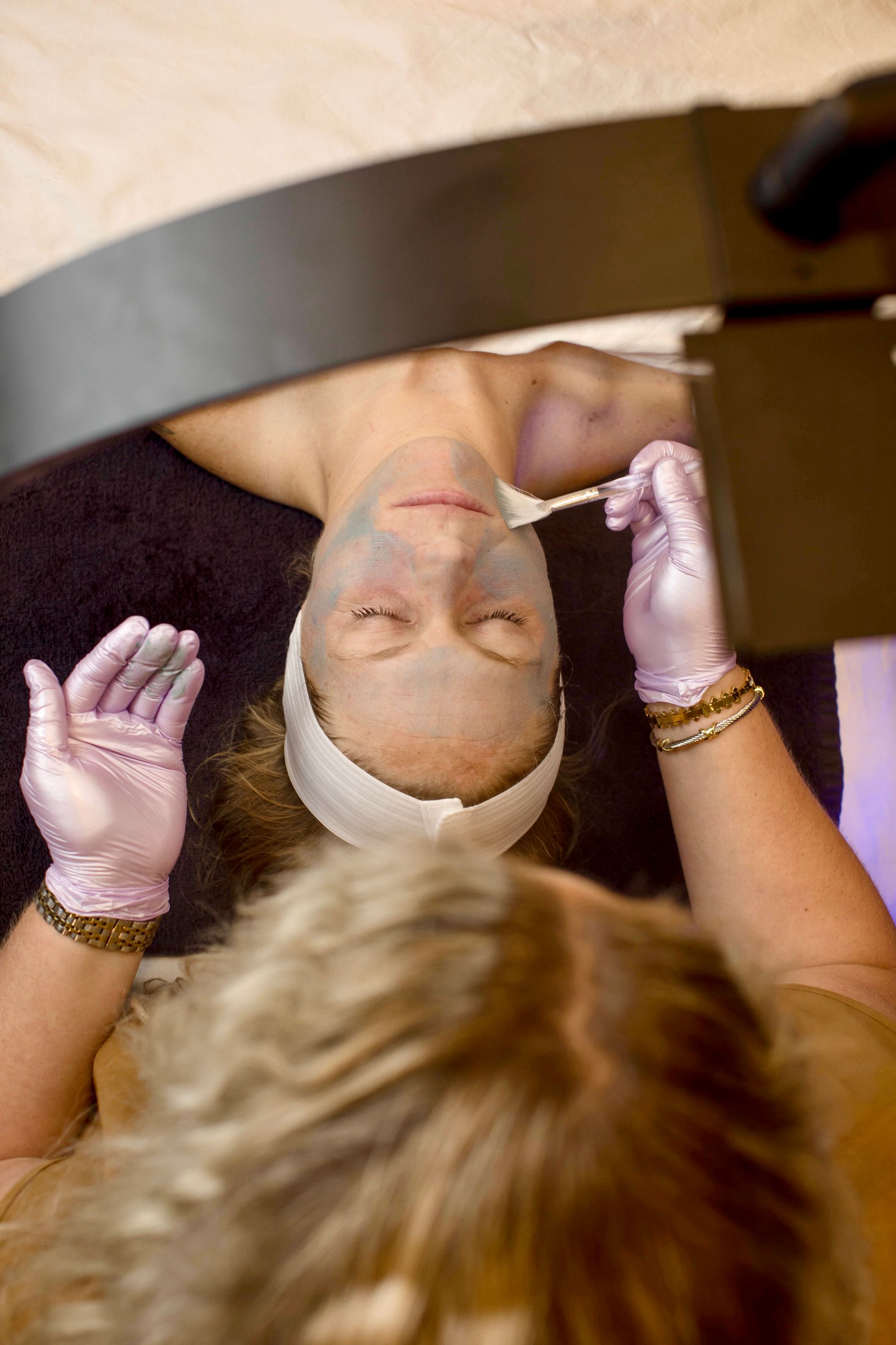 A woman is getting a facial treatment at a spa.