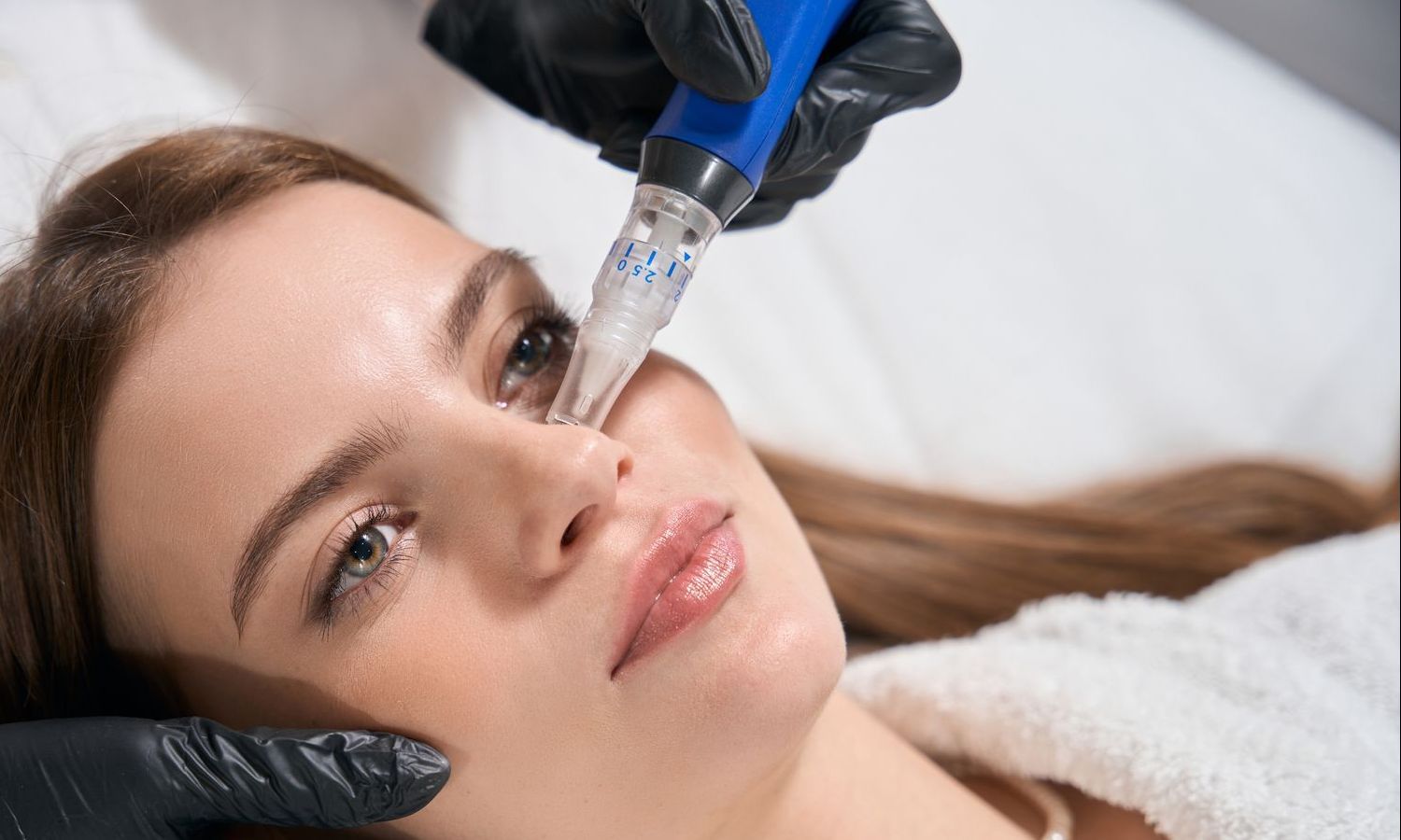 A woman is getting a treatment on her face with a machine.