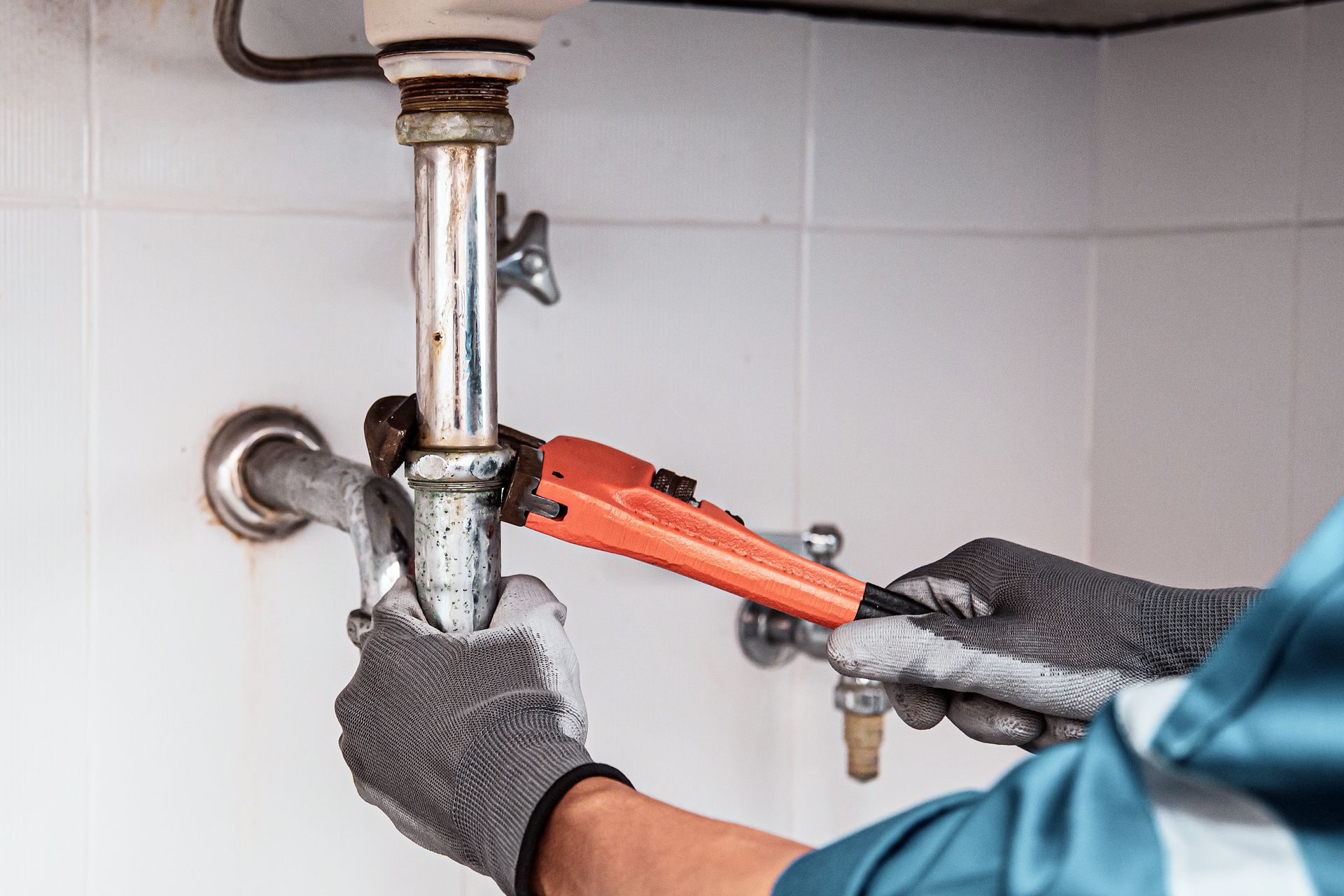 a plumber is fixing a pipe with a wrench a plumber is fixing a pipe with a wrench