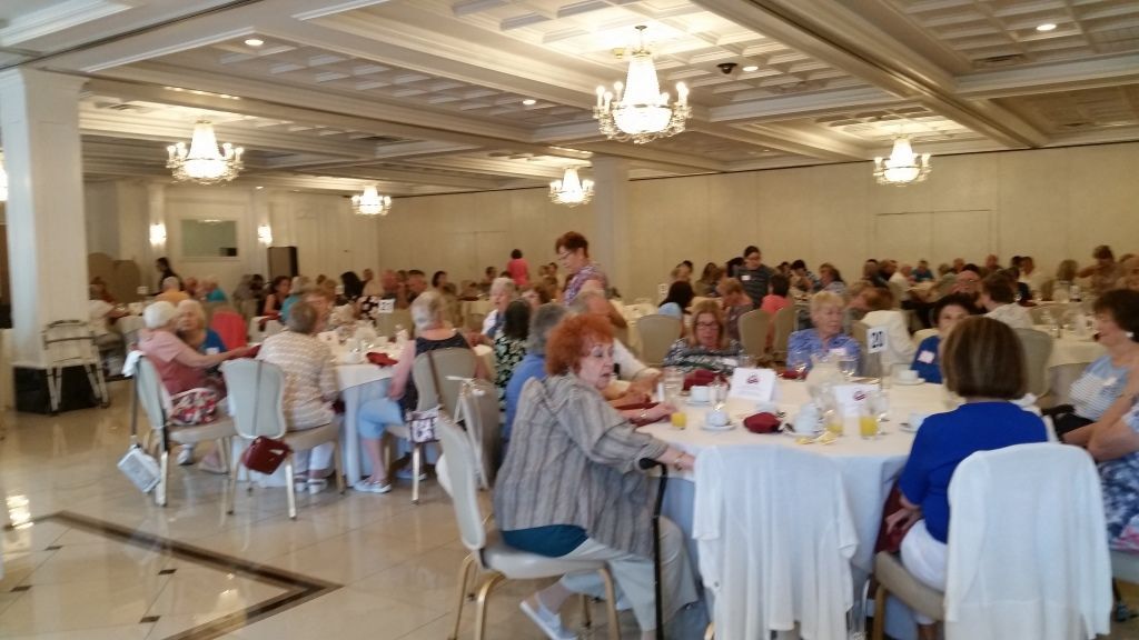 Banquet hall with guests seated at round tables during a formal gathering