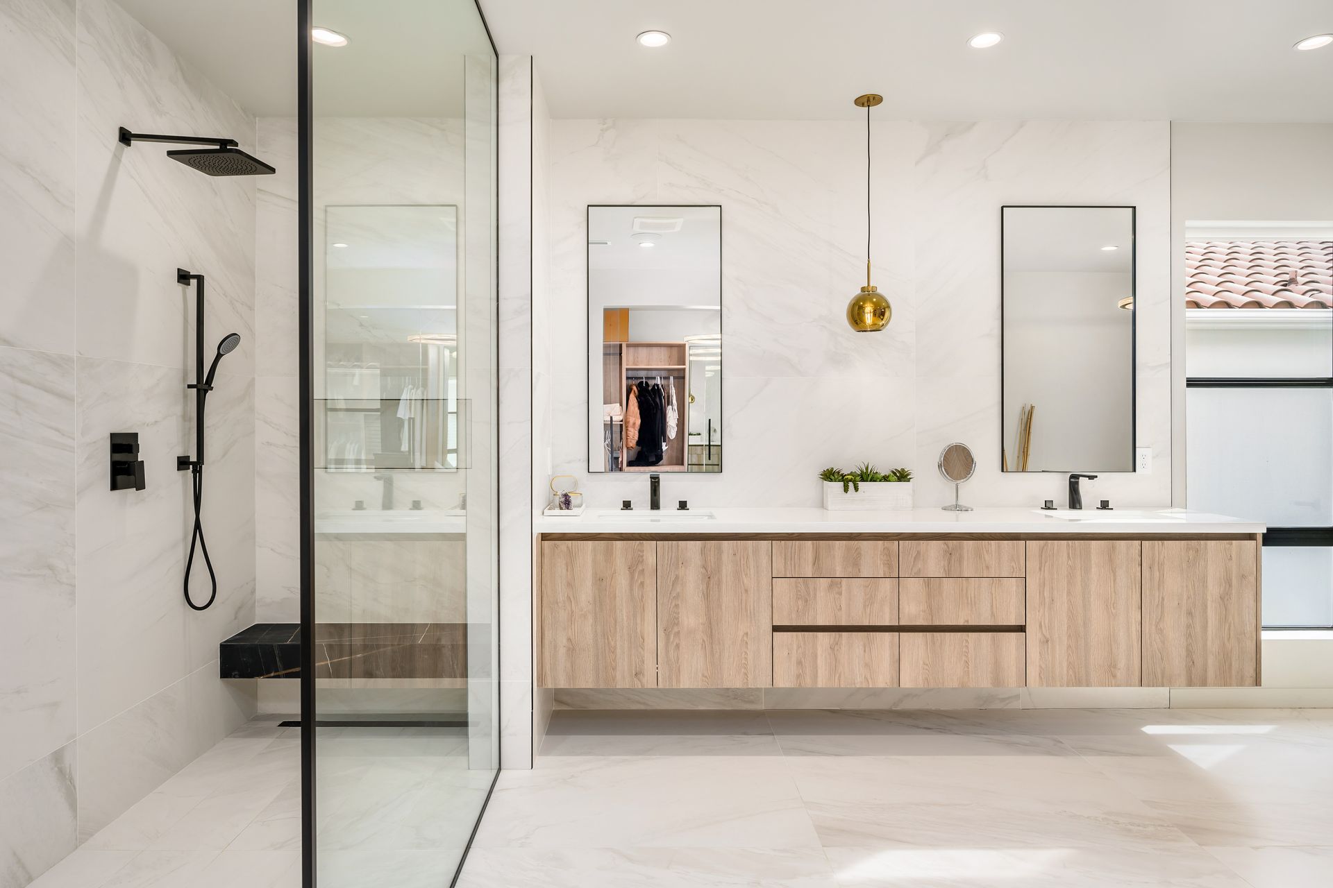 Modern luxury home bathroom with floating vanity and glass shower.