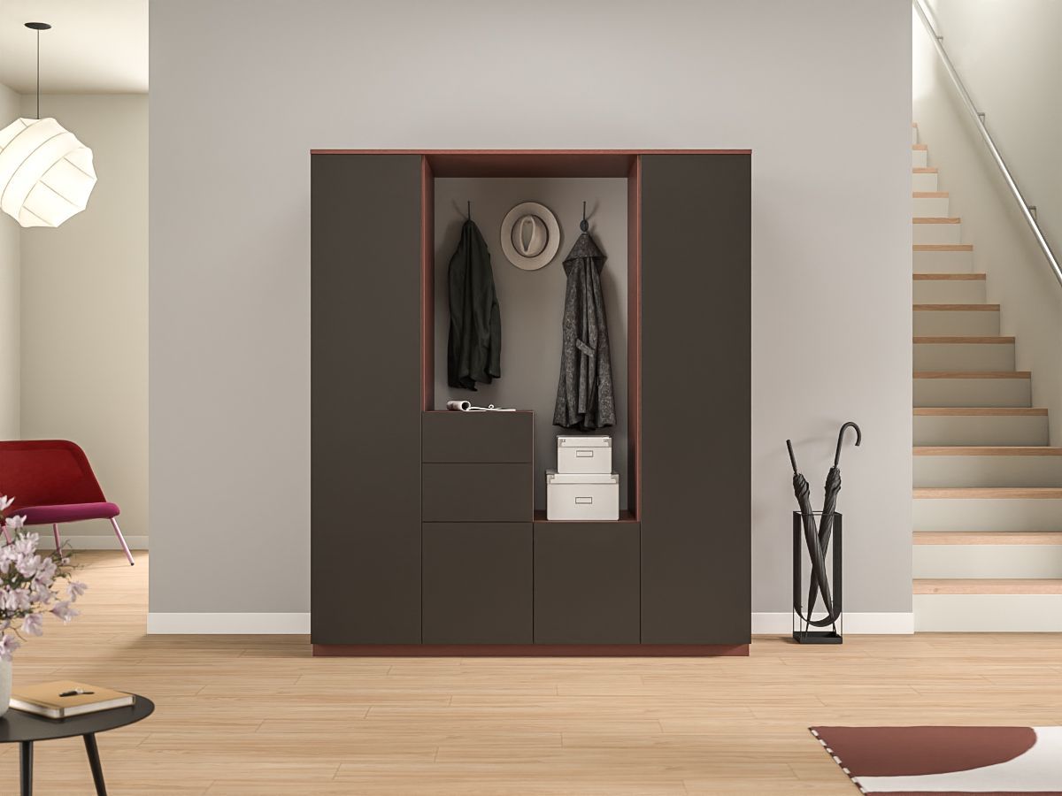 Moderner Eingangsbereich mit dunkler Garderobe, hängender Kleidung, weißer Treppe und hellem Holzboden