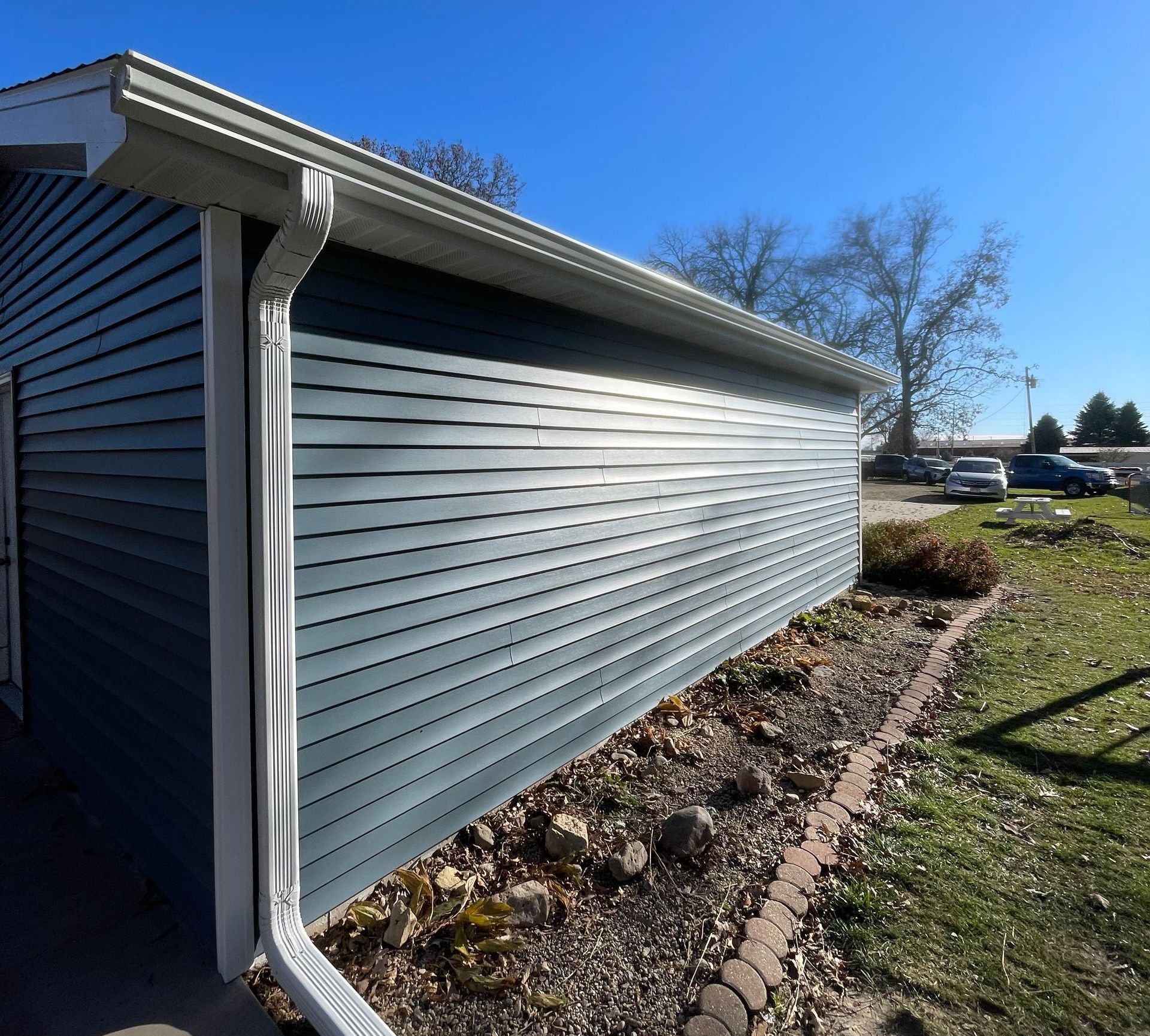 A house with a gutter on the side of it.