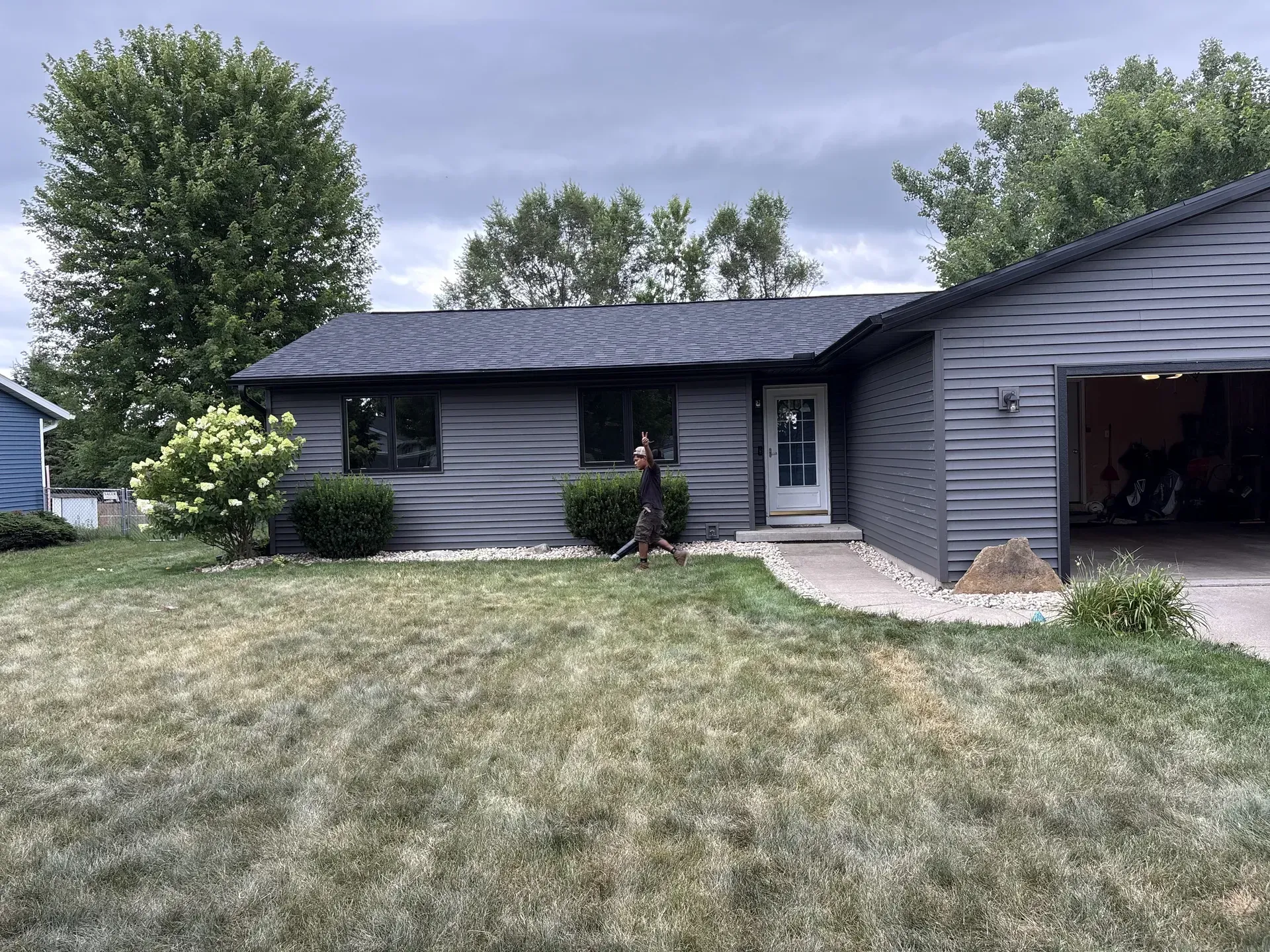 New black seamless gutters installed along the front roofline of a ranch home in Janesville, WI