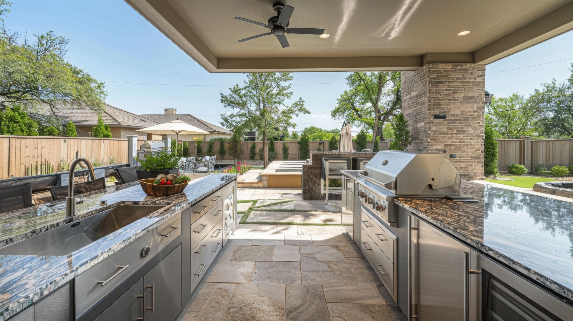 Custom outdoor kitchen with stainless cabinetry and grill
