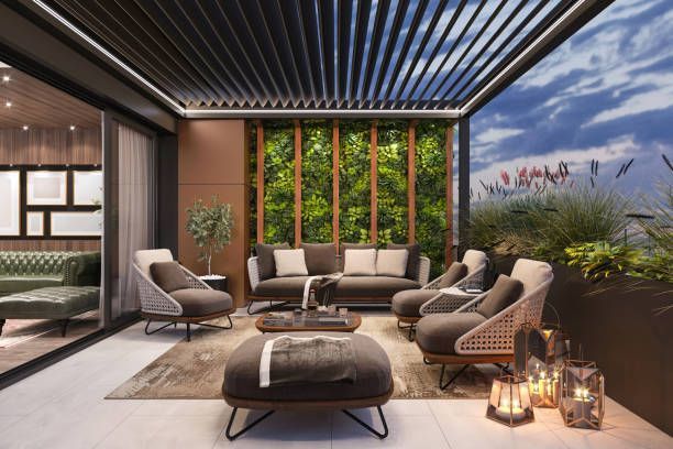 Modern lounge terrace with woven chairs, ottoman, striped ceiling, and sunset garden view