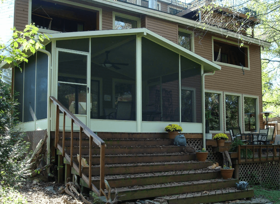 House with screened porch and wooden steps leading up to a front entrance