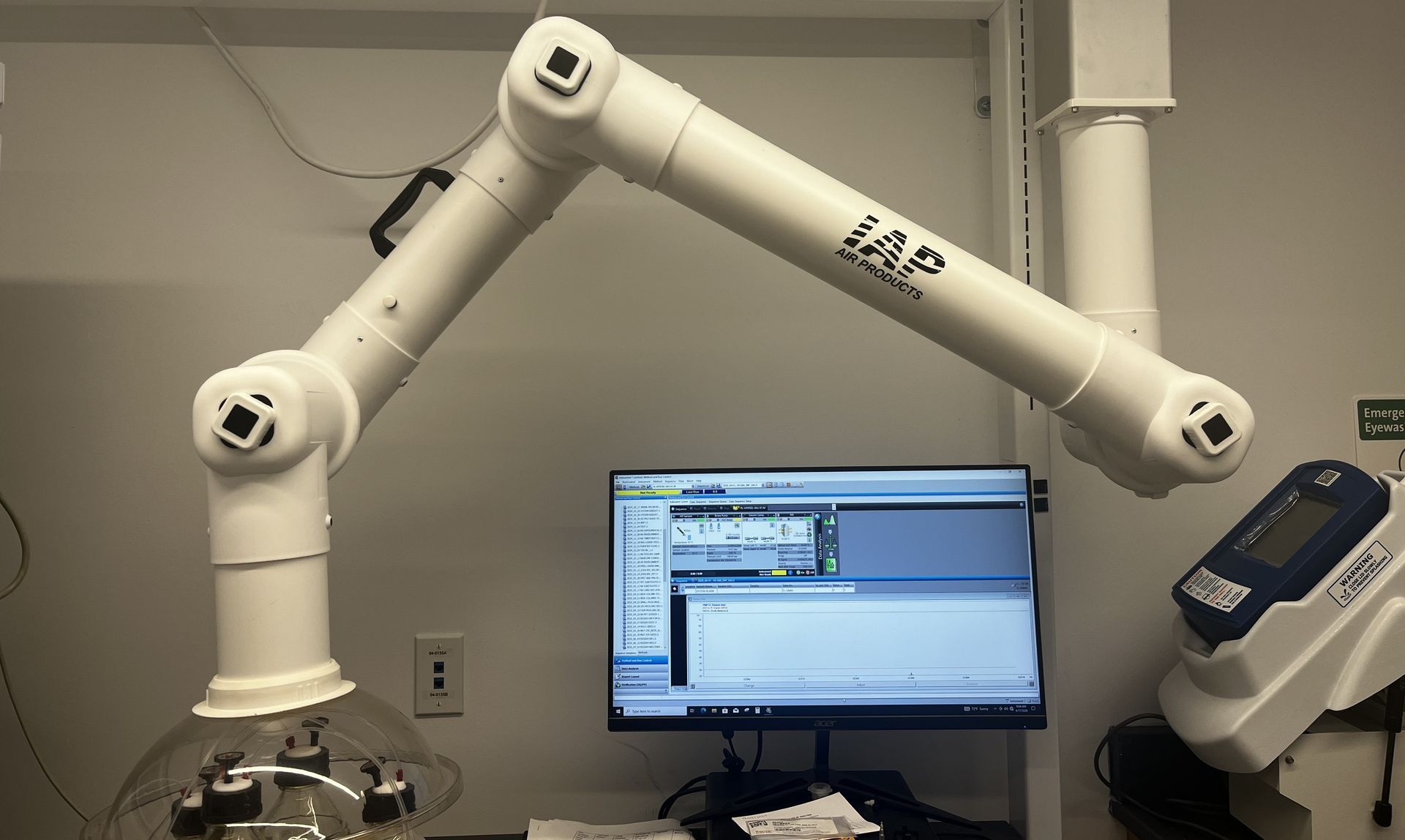 Laboratory fume extraction arm in use in lab environment