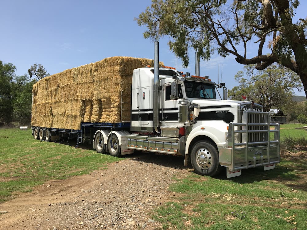 Pile of Hay on Drop Deck Truck — Freight Transport in Wagga Wagga, NSW