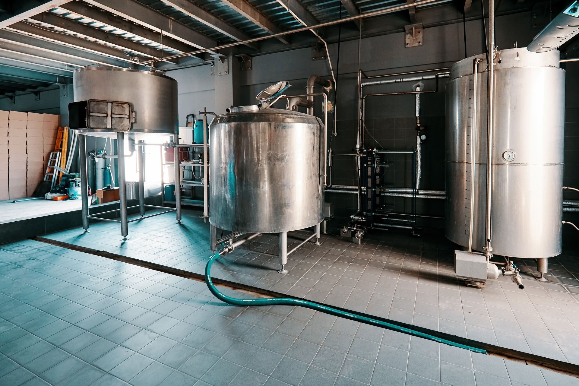 A man fixing a gate valve | Queensland | East Coast Steam Boiler tanks in a brewery factory