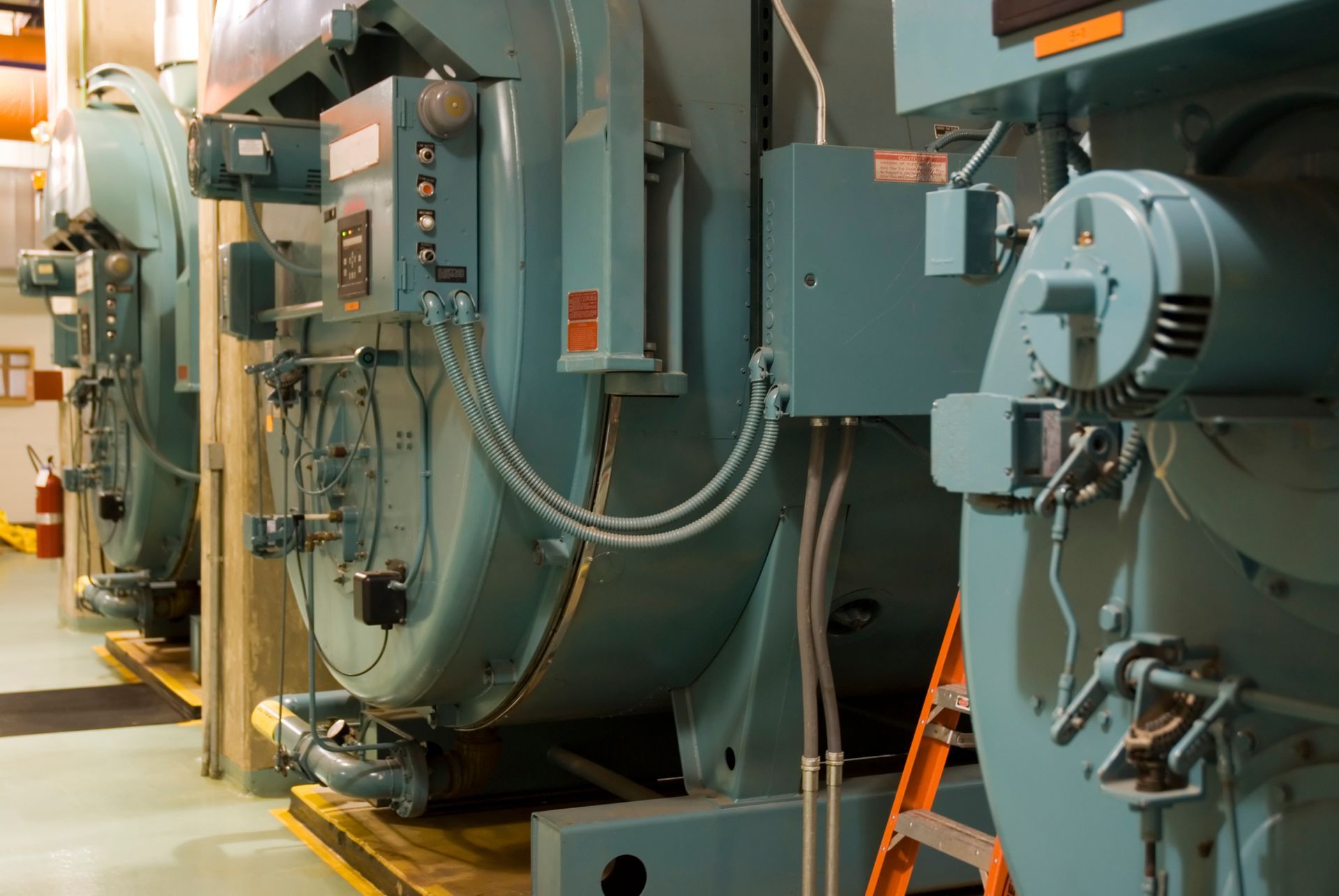 Industrial boilers supply with large steel boiler systems in factory interior.
