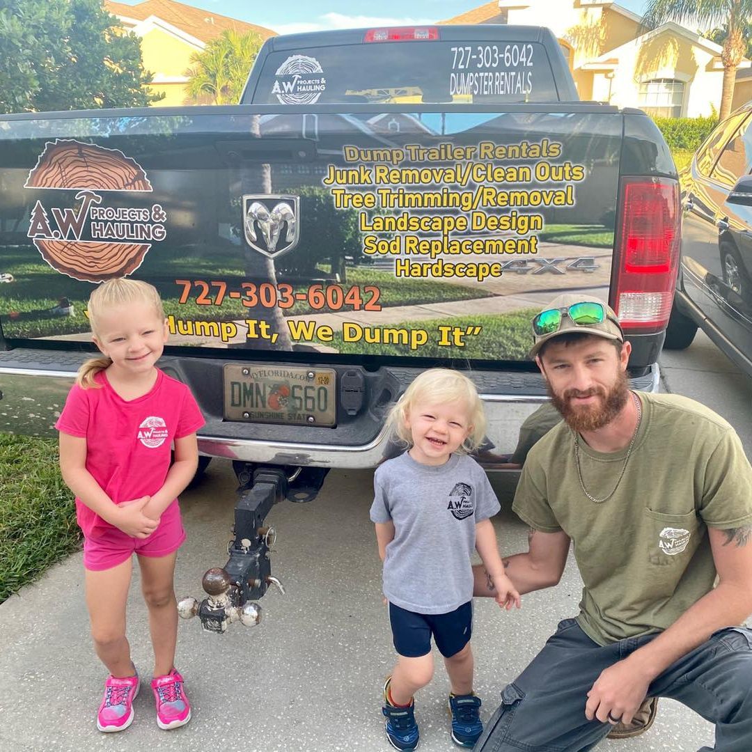 A Spencer Silver and his two children pose in front of a truck