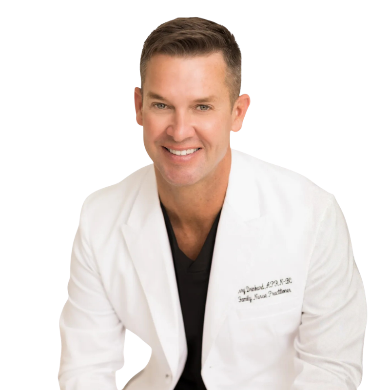 Professional headshot of Jerry Drinkard smiling in a white clinic coat, an aesthetics industry expert at Dr. Croley Aesthetic MD in Pace, Florida.