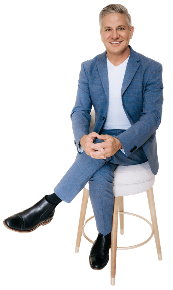 Professional headshot of Dr. Croley smiling in a blue blazer, medical director at Skin & Tonic in Pace, Florida.