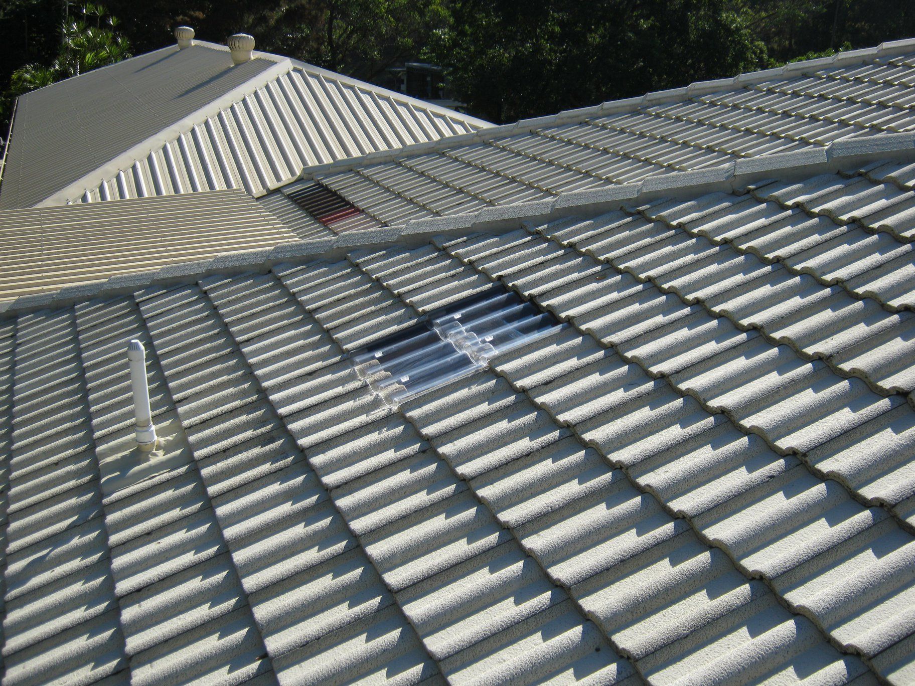 A Couple Of People Are Working On A Roof — Gold Coast Roof Repairs in Palm Beach, QLD