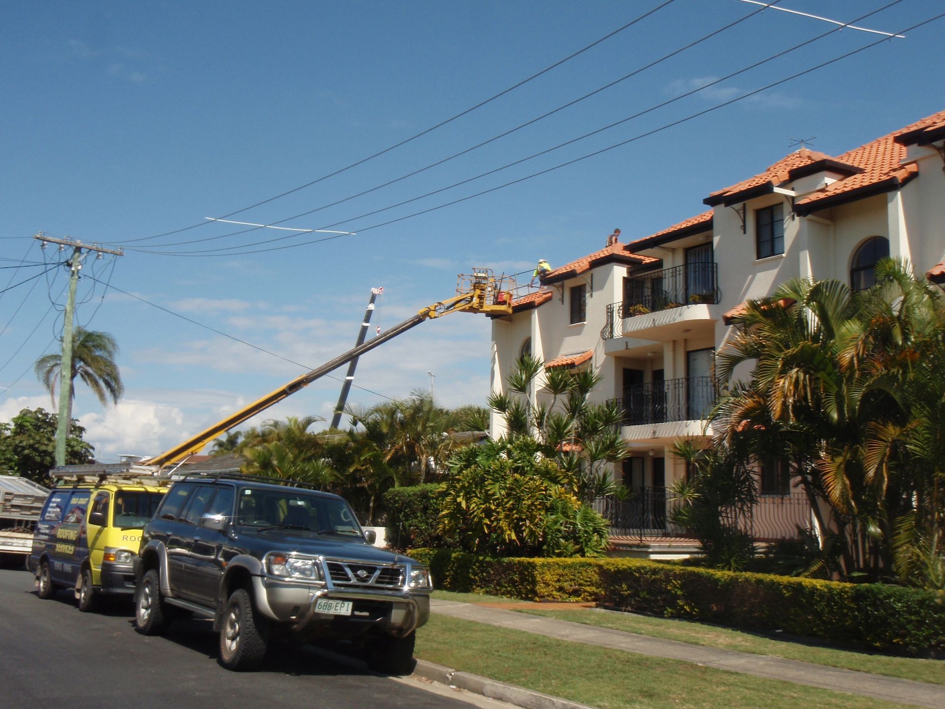 An Empty Roof Of A Building With A City — Gold Coast Roof Repairs in Ormeau, QLD