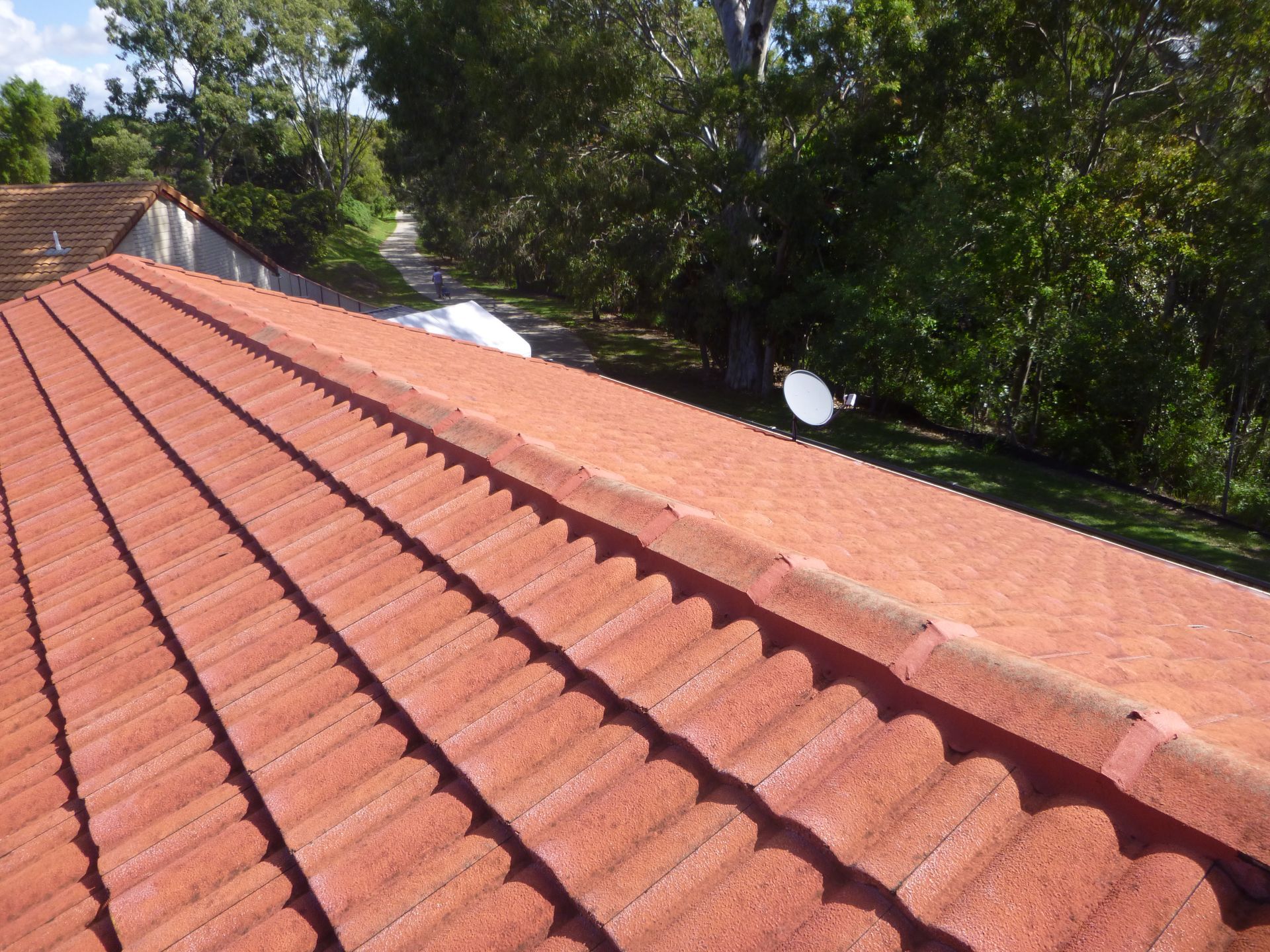A Tiled Roof With A Blue Sky — Gold Coast Roof Repairs in Mudgeeraba, QLD
