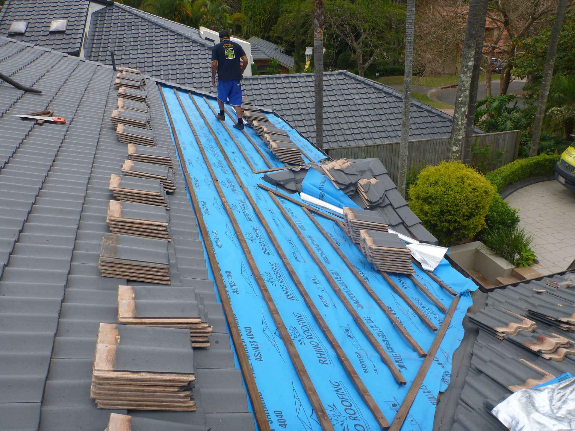 A Row Of Red Tiles On A Roof — Gold Coast Roof Repairs in Ormeau, QLD