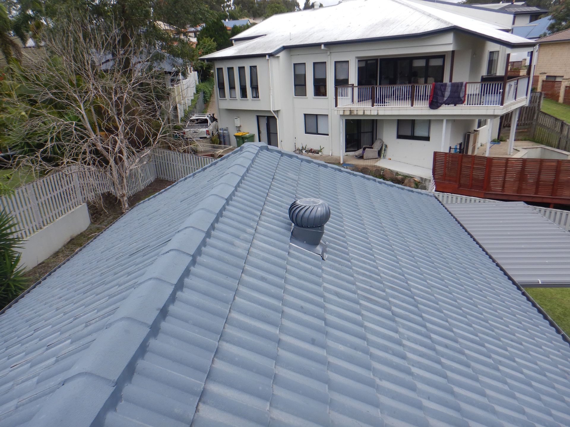 An aerial view of a house with a gray roof