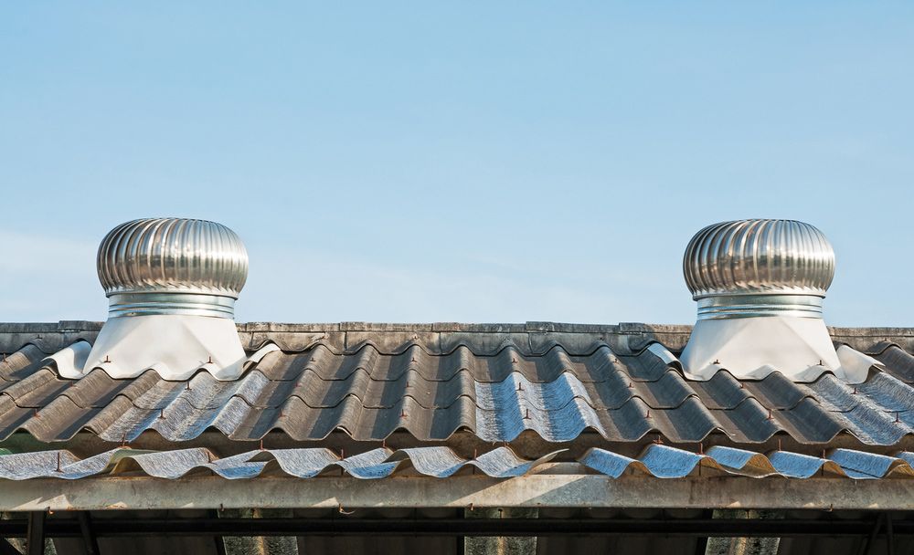 Two Metal Whirlybirds on Roof