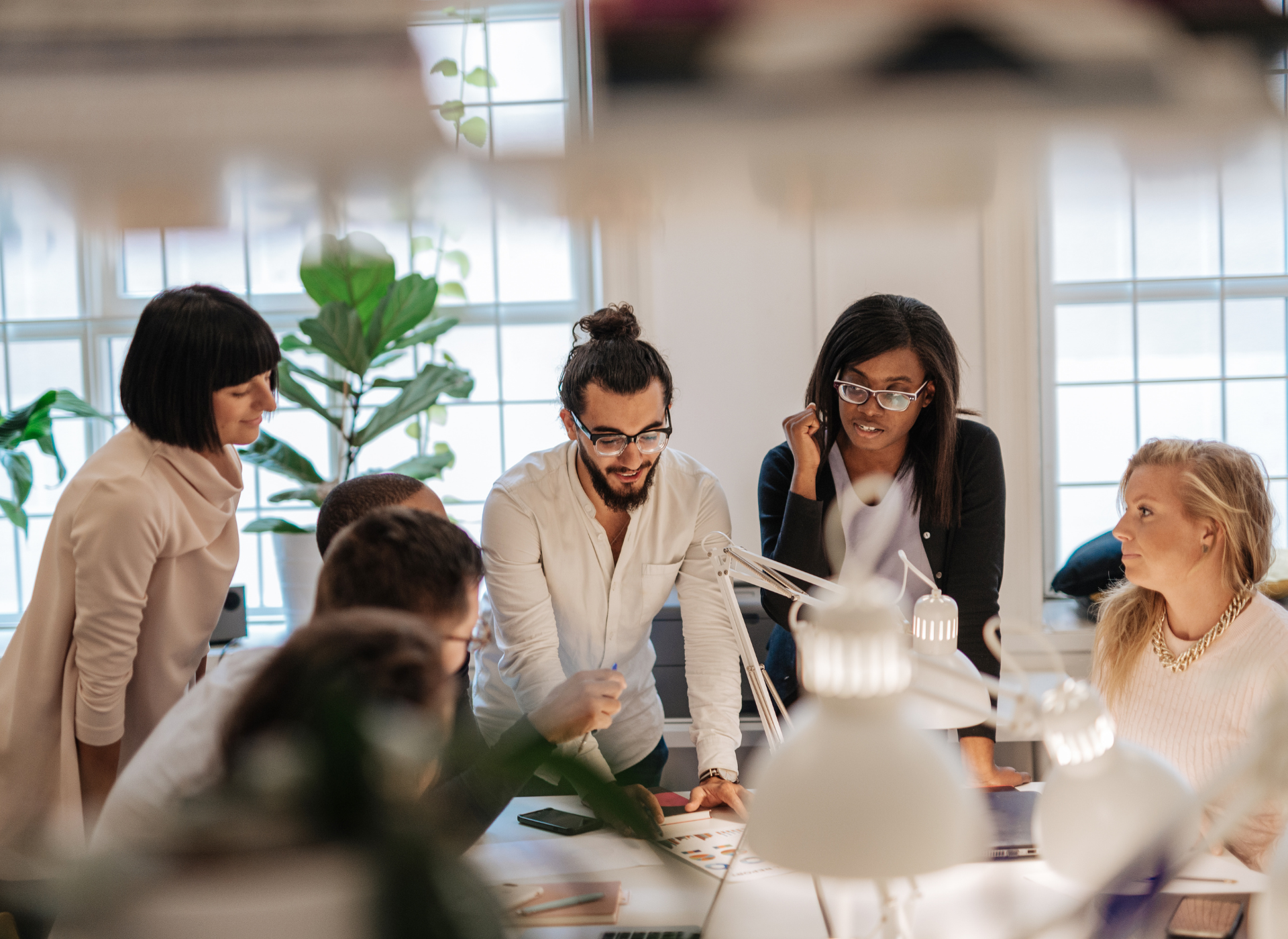 A group of people are having a meeting in an office.