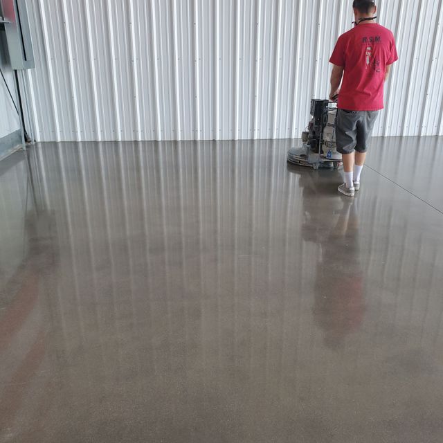 An empty room with polished concrete floors and white walls.