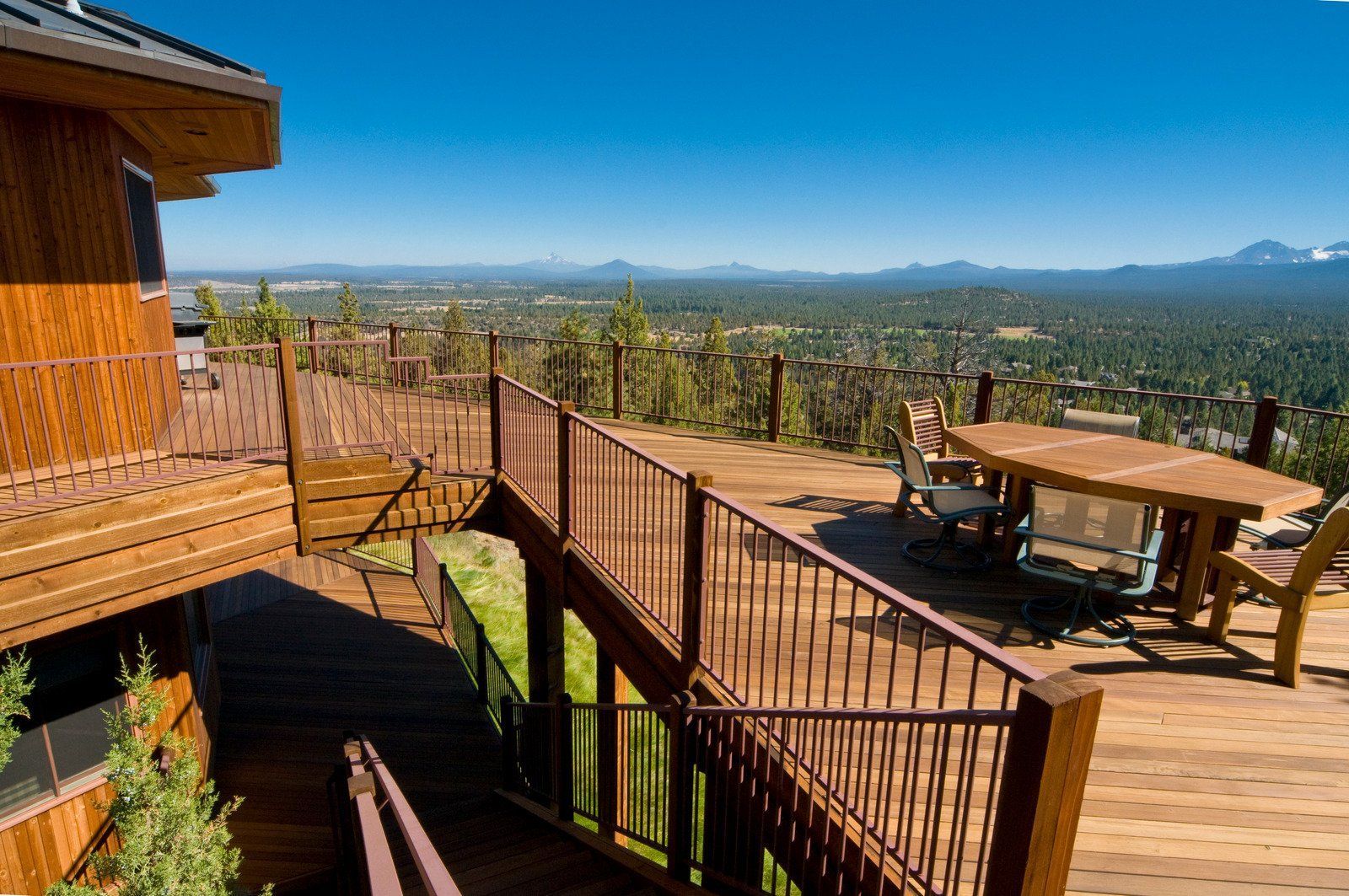 A wooden deck with a table and chairs on it