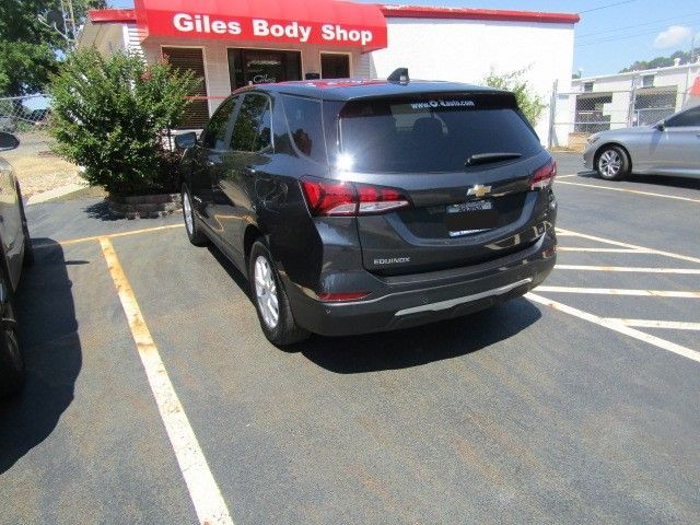 Black Chevrolet SUV parked in a lot outside Giles Body Shop