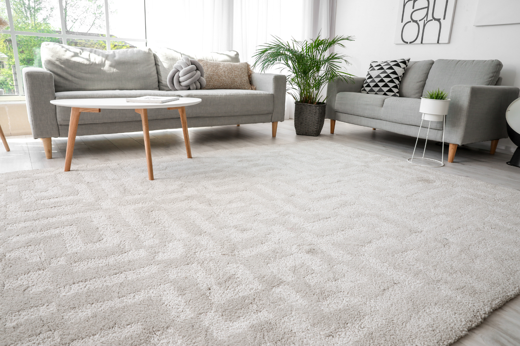 A living room with a couch , table , and rug.
