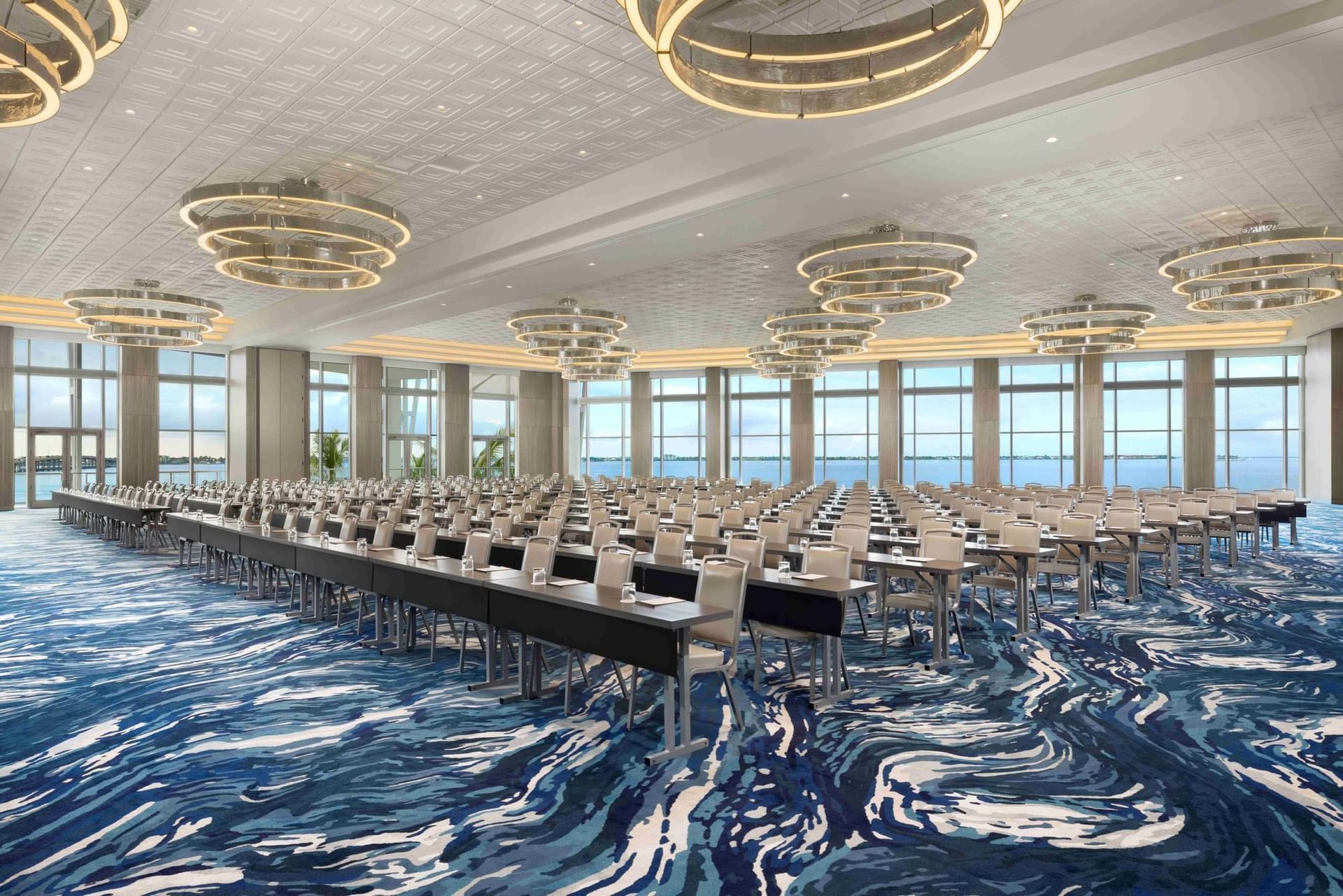 An artist 's impression of a large conference room with tables and chairs.